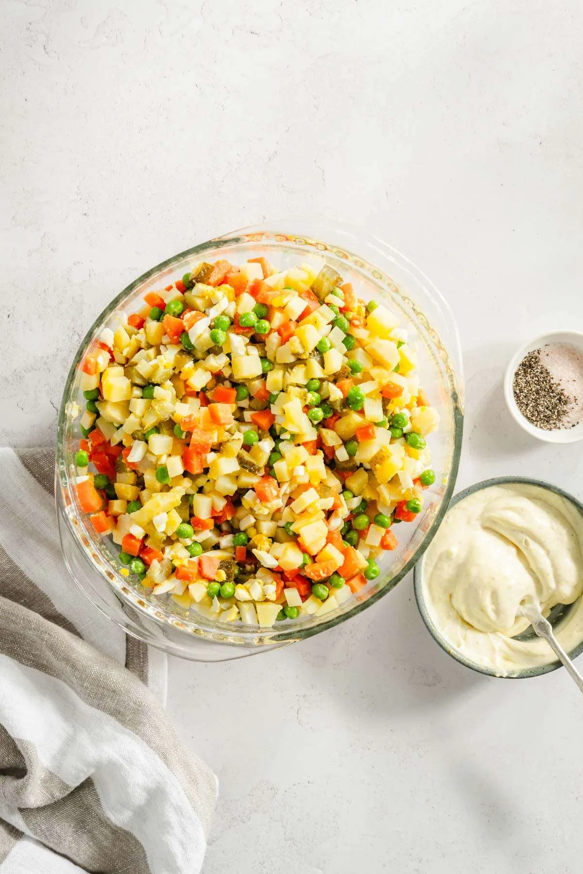 small dish with the dressing mixed in, bowl with the salad