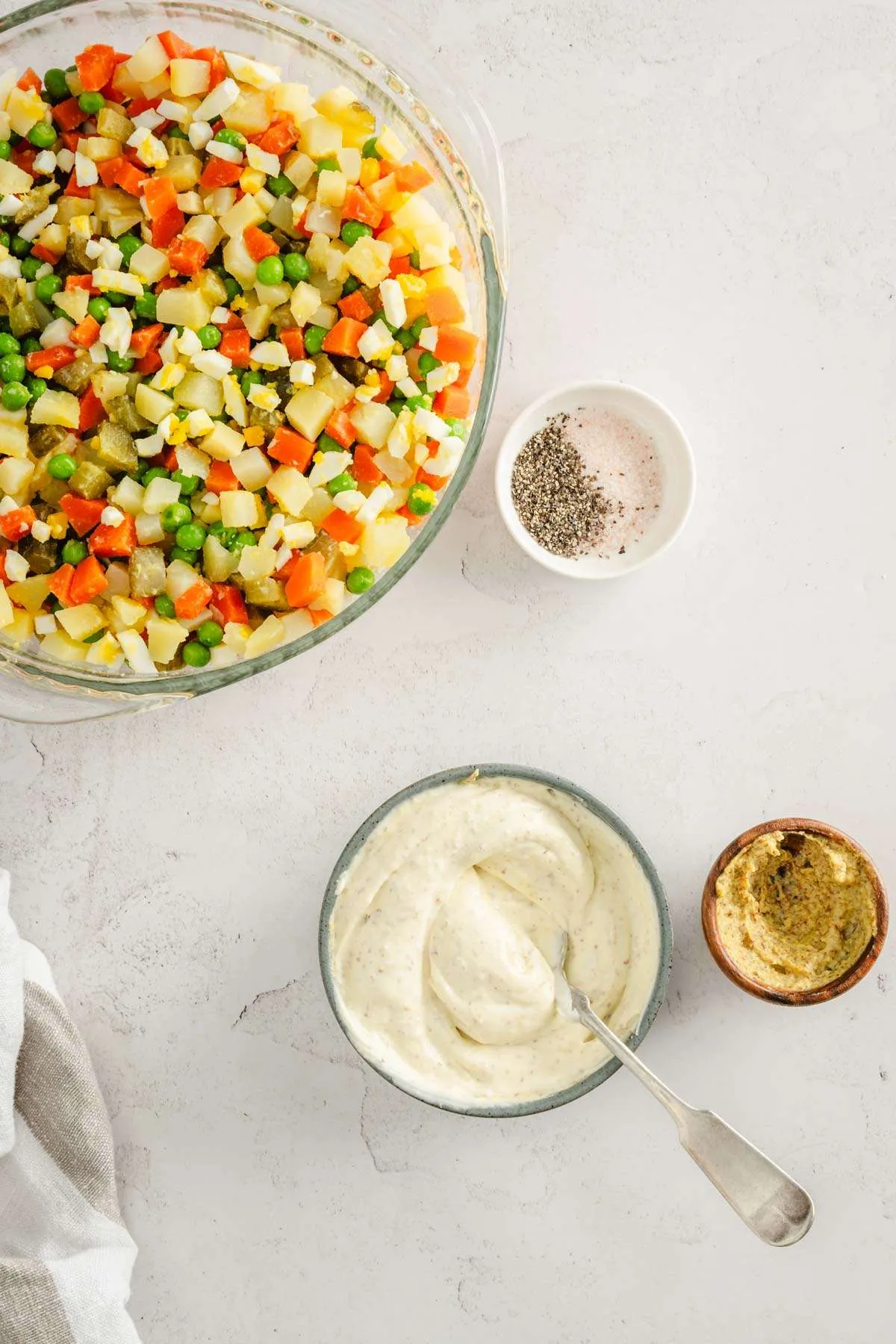 small dish with the dressing mixed in, bowl with the salad