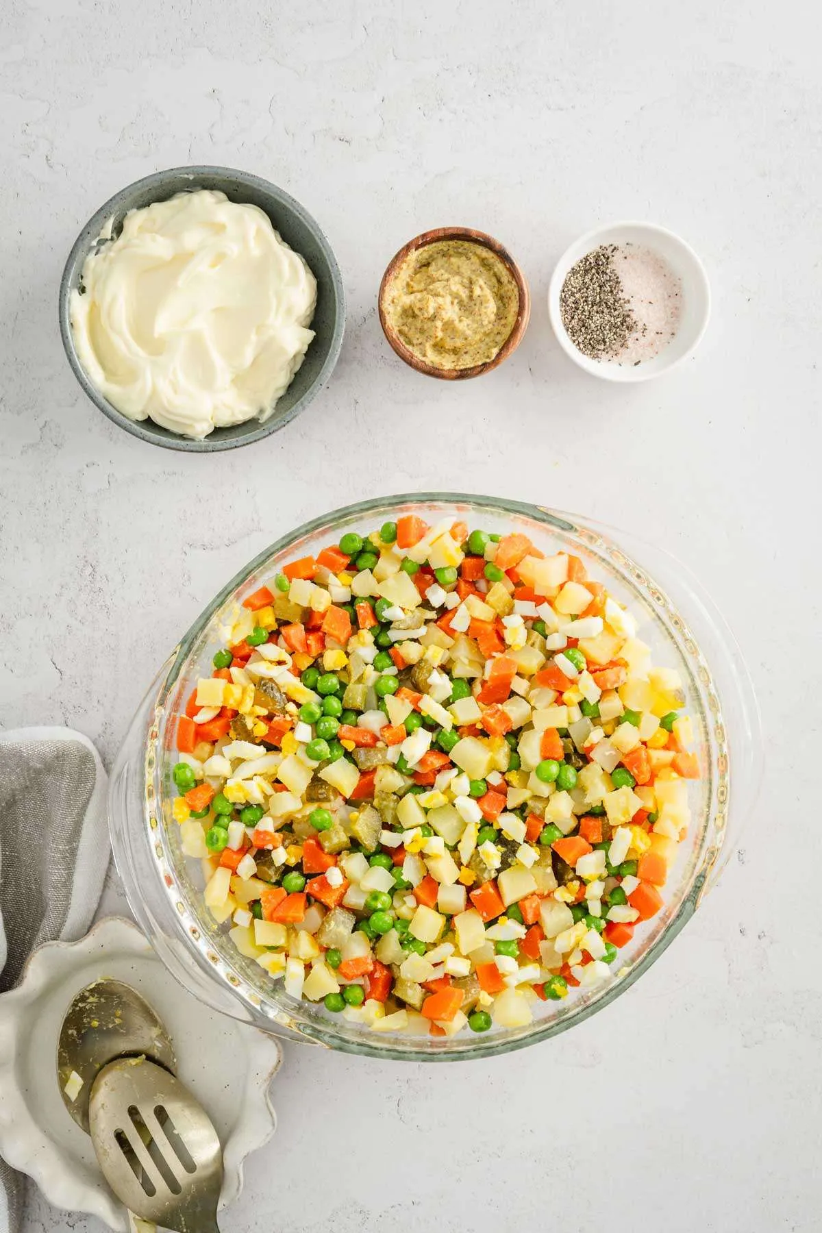 cut up veggies in a large bowl, dish with mayo, mustard, salt and pepper on the side
