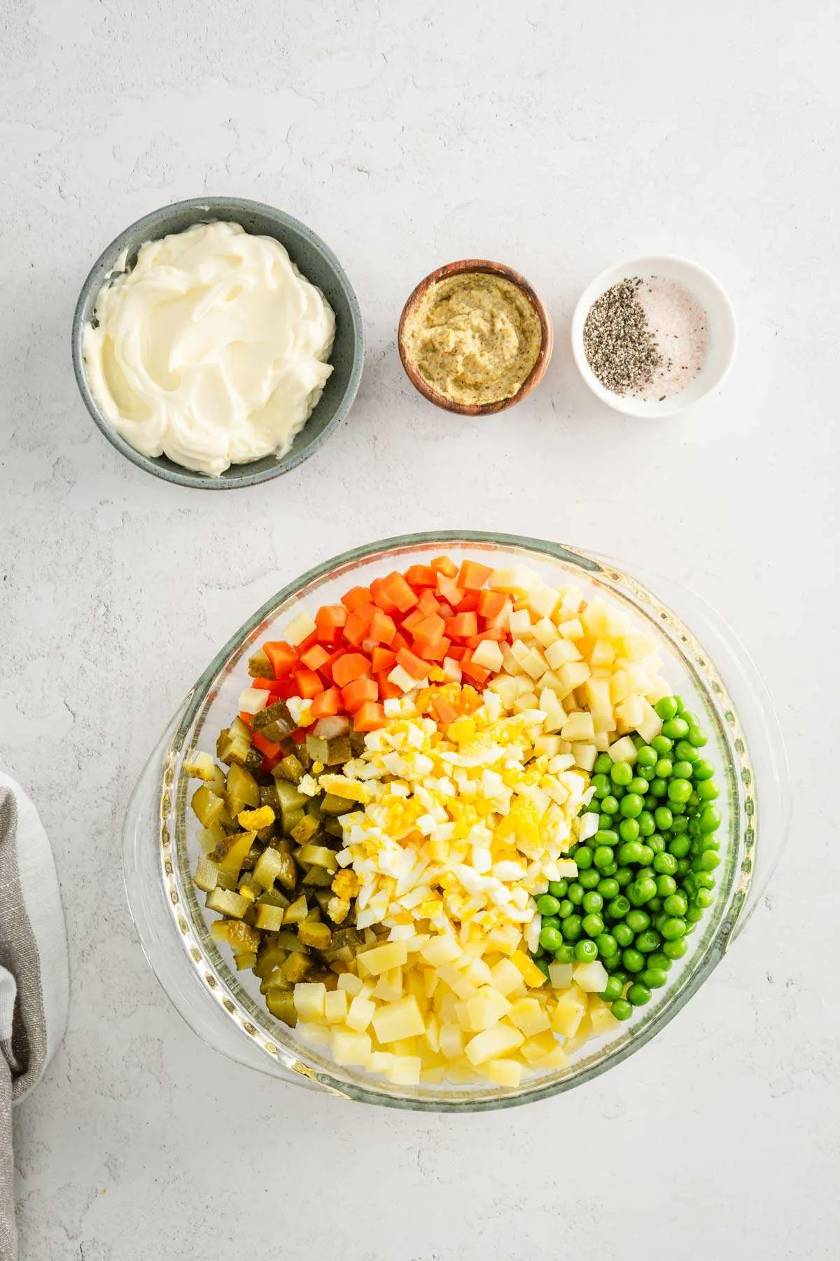 cut up veggies in a large bowl, dish with mayo, mustard, salt and pepper on the side