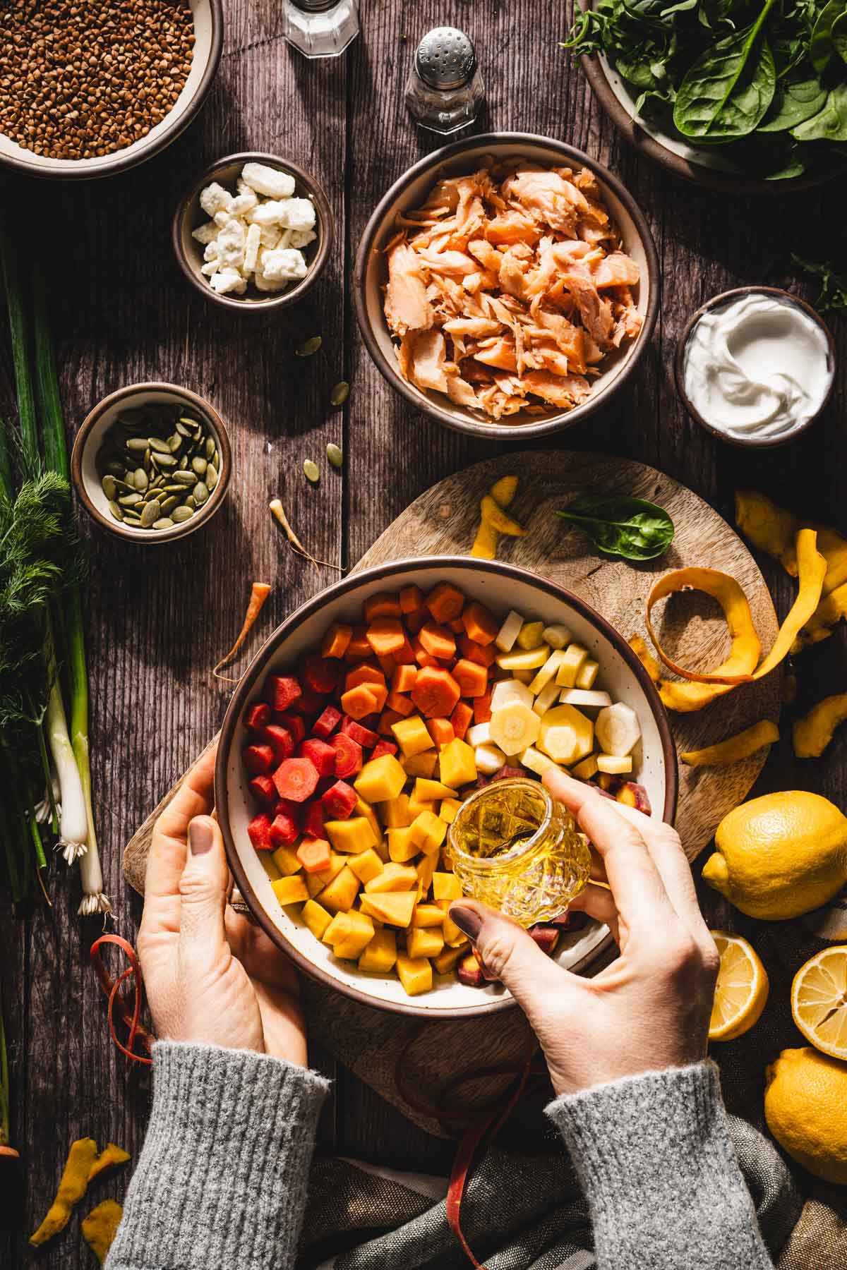 hands in frame pouring oil over the veggies