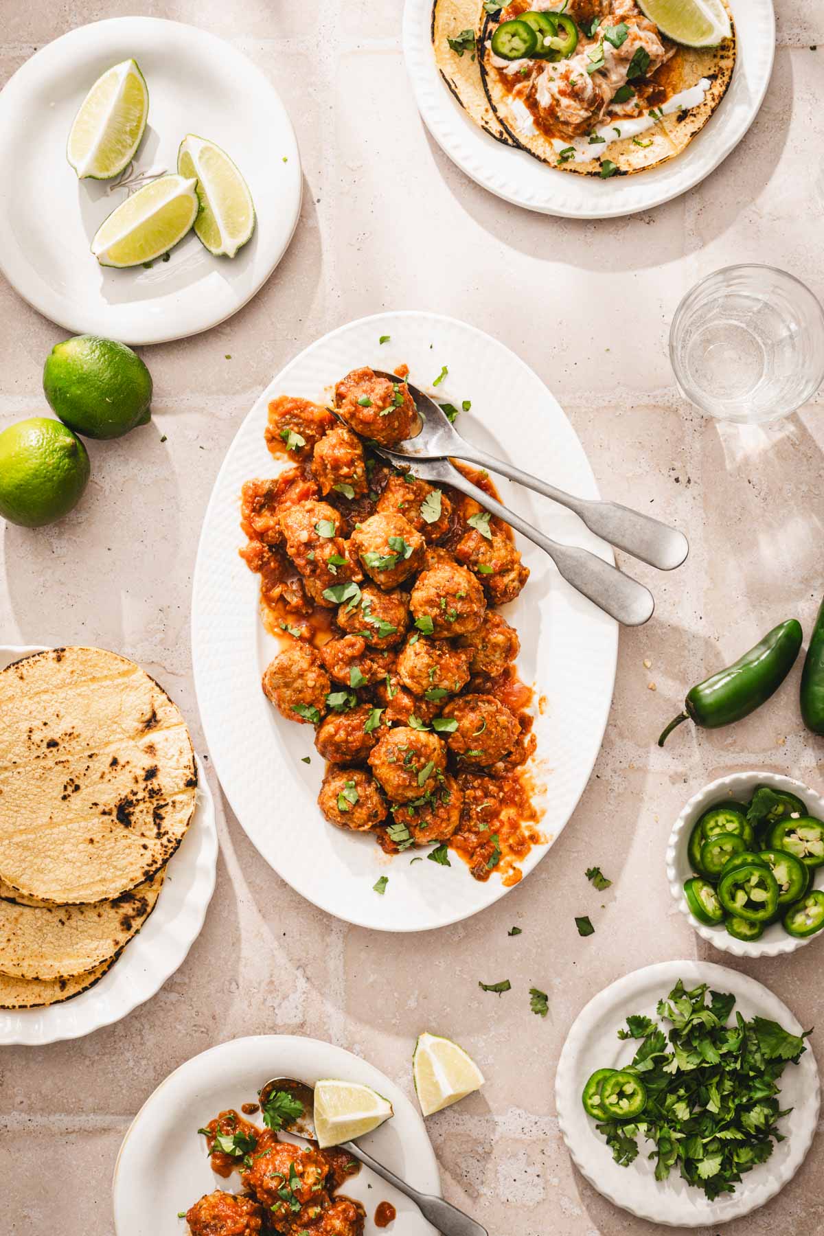 serving plate with cooked meatballs, other plates around