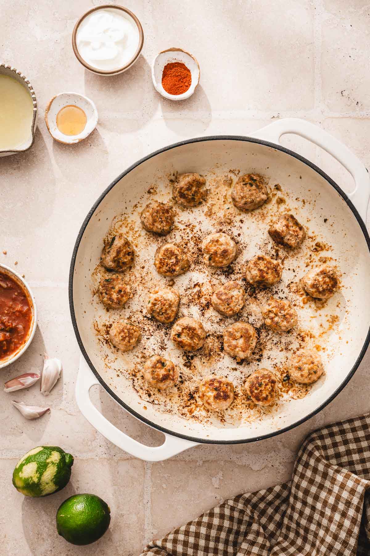 large skillet with cooked meatballs