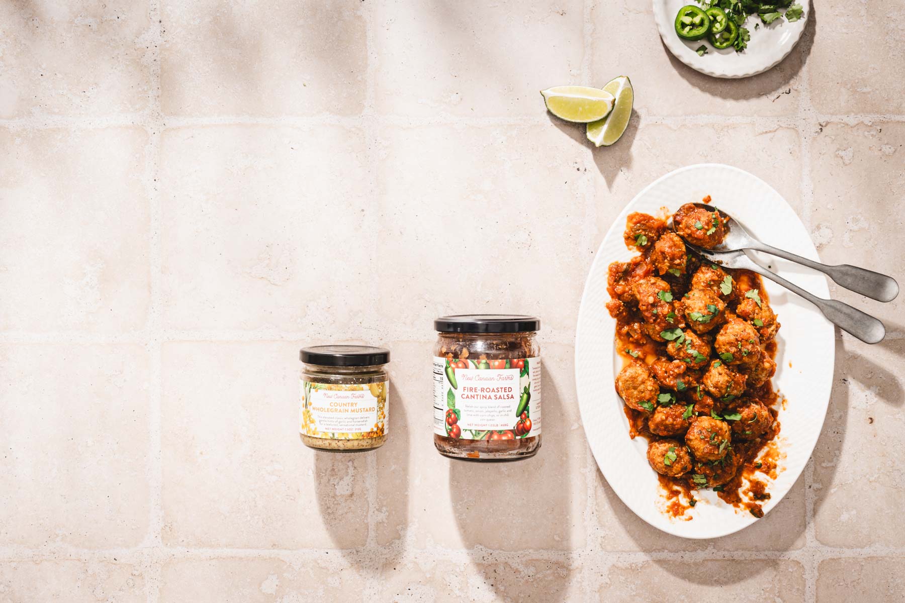 horizontal photo, serving plate with meatballs, jars with the ing