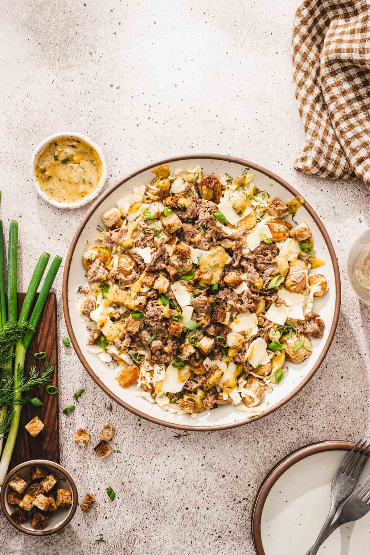 made salad in a serving bowl, cutting board, napkin