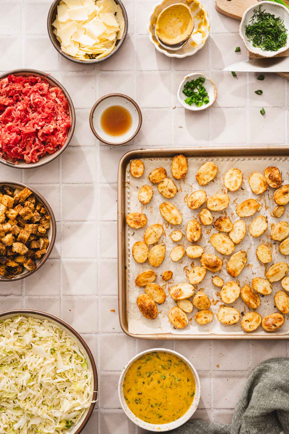 ing to make the salad, baking tray with roasted potatoes