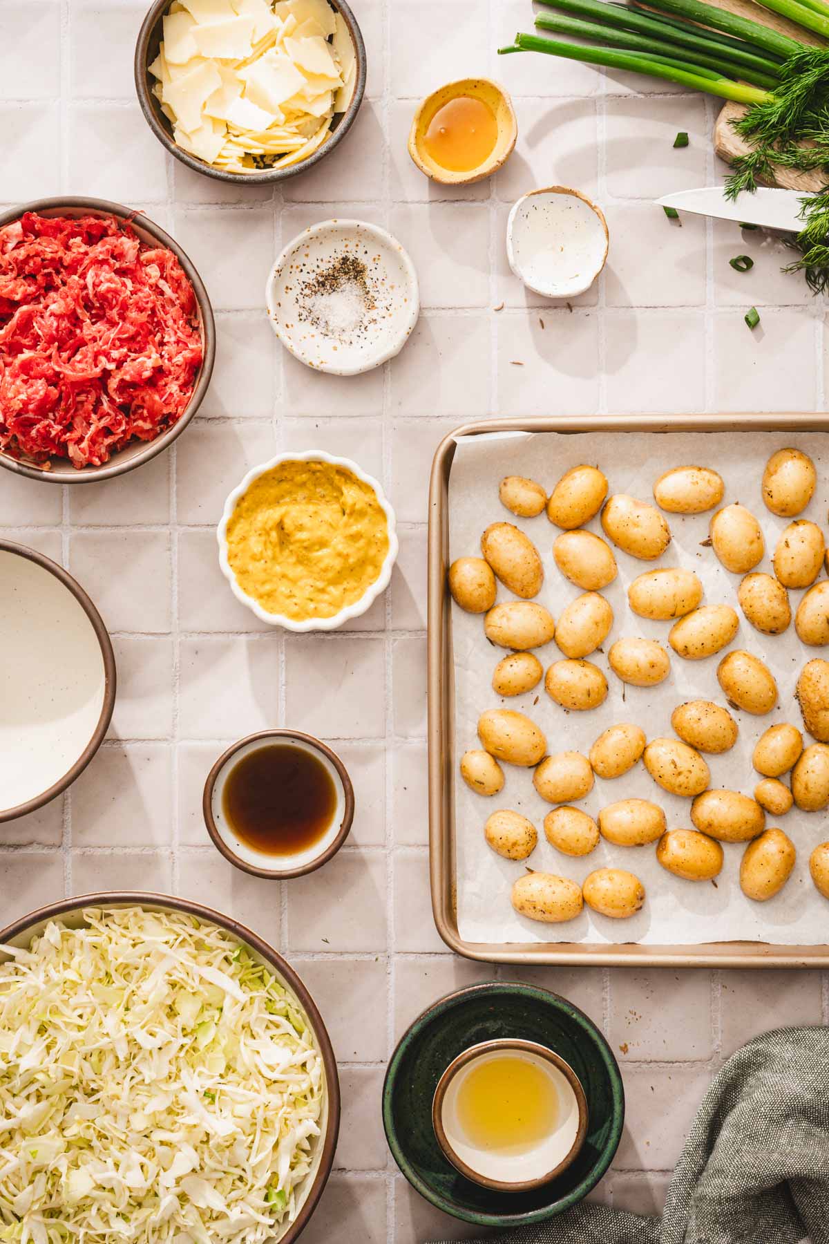 ing to make the salad, baking tray with haleved potatoes