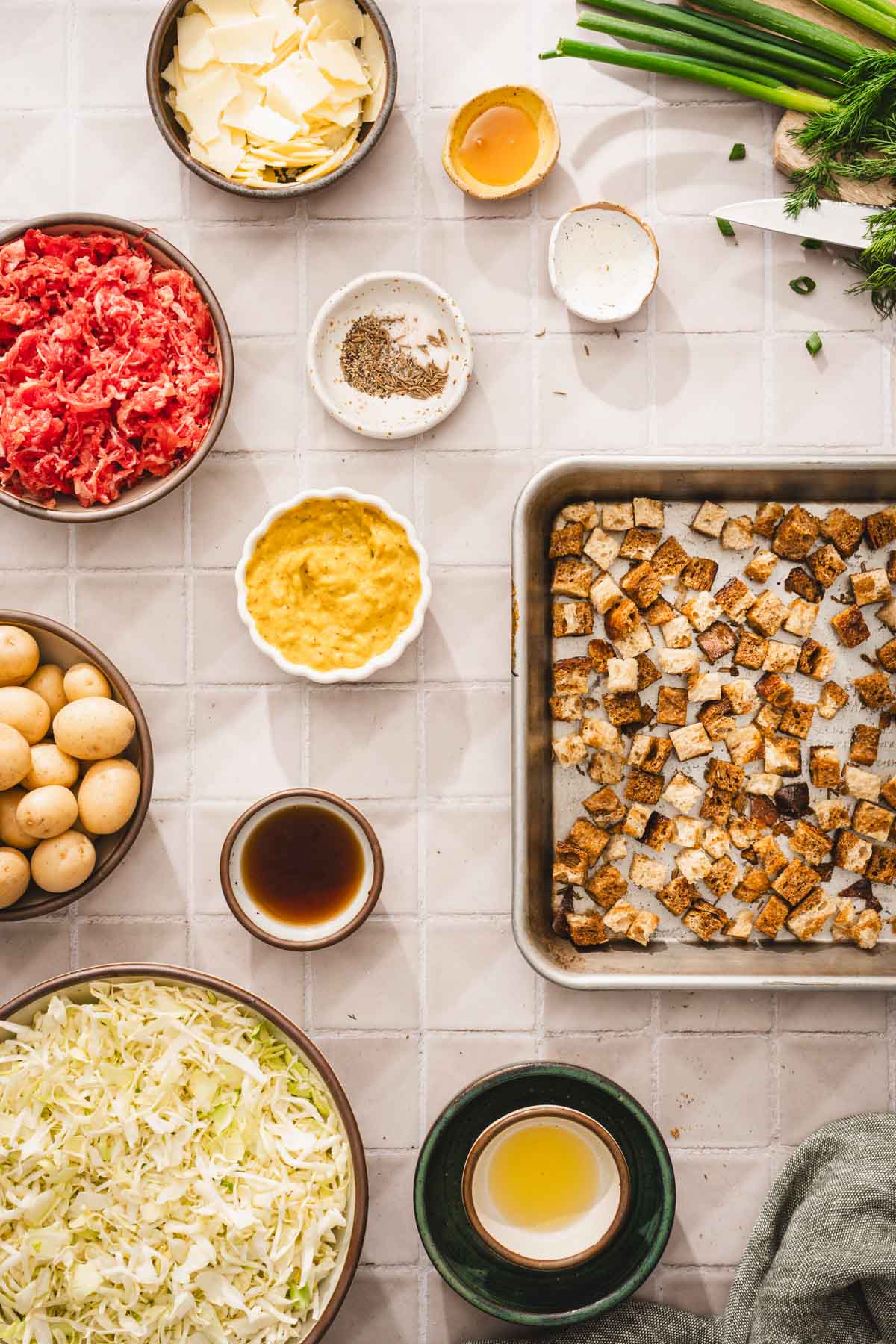 ing to make the salad, baking tray with cubbed bread