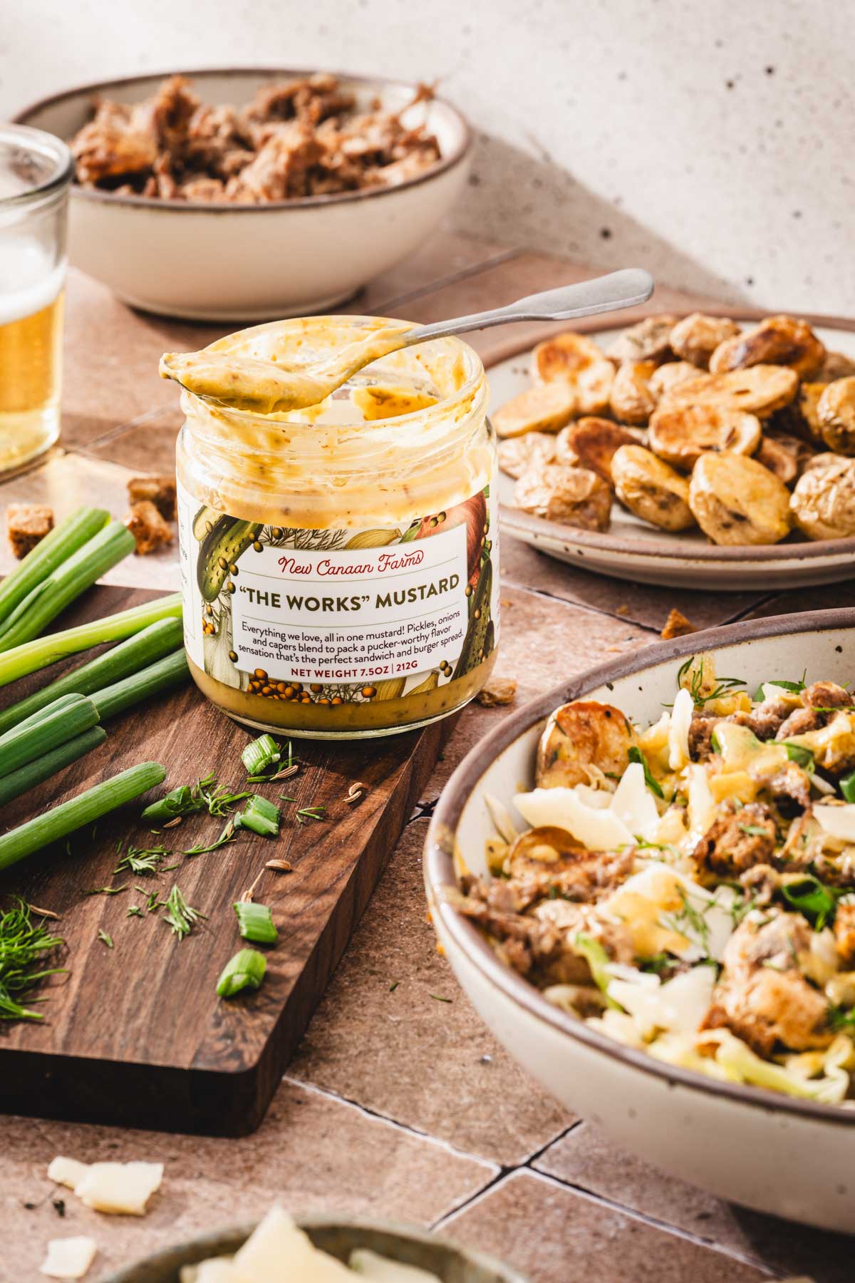 open jar with mustard, dishes with the salad