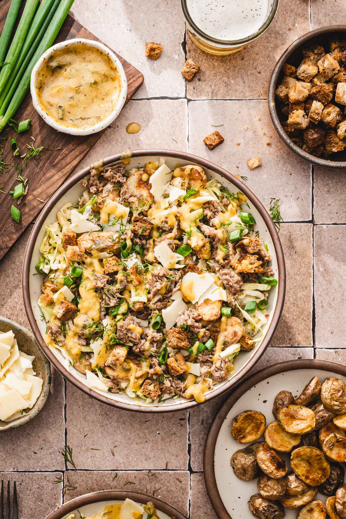 close up of a bowl with bf salad, other plates around