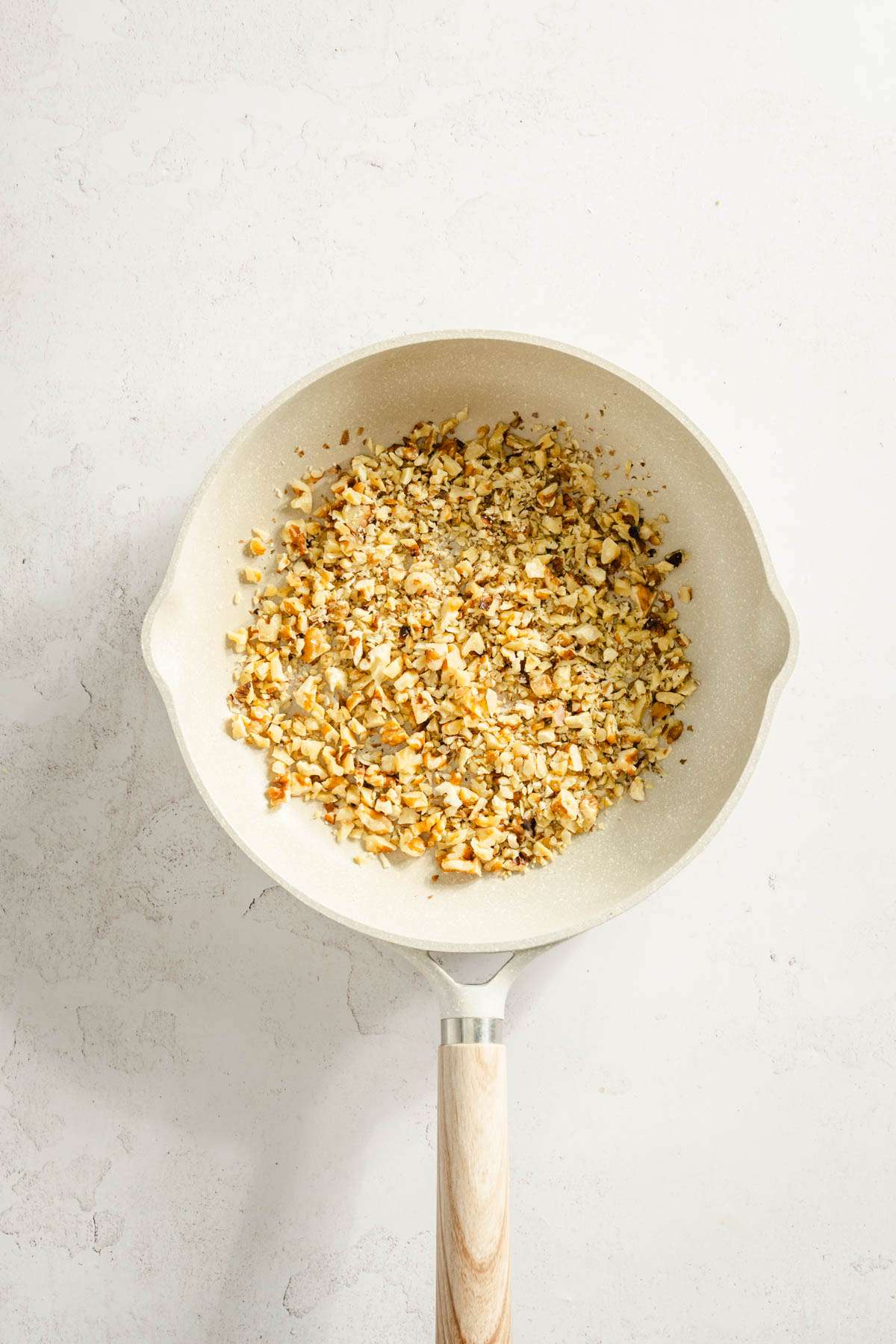 chopped walnuts on a frying pan, raw