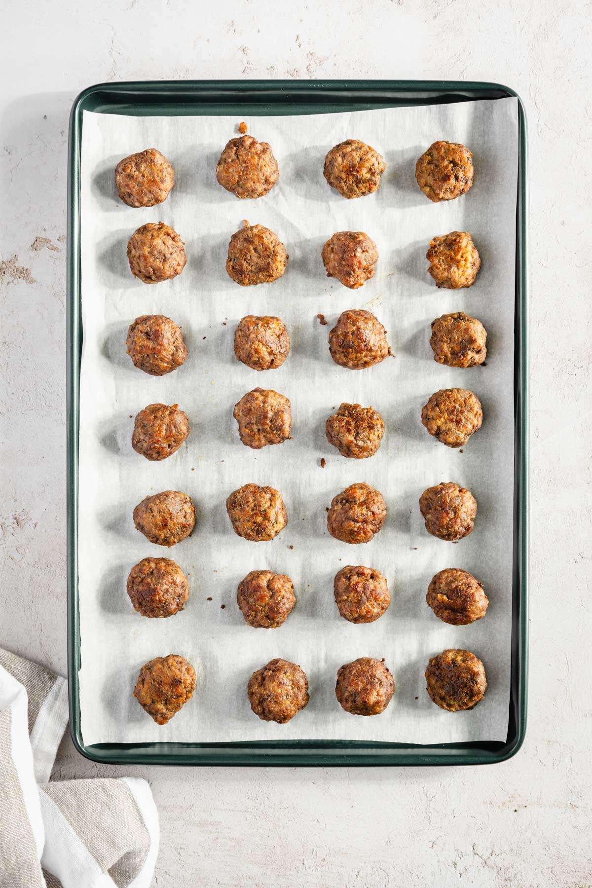 cooked meatballs on a baking sheet