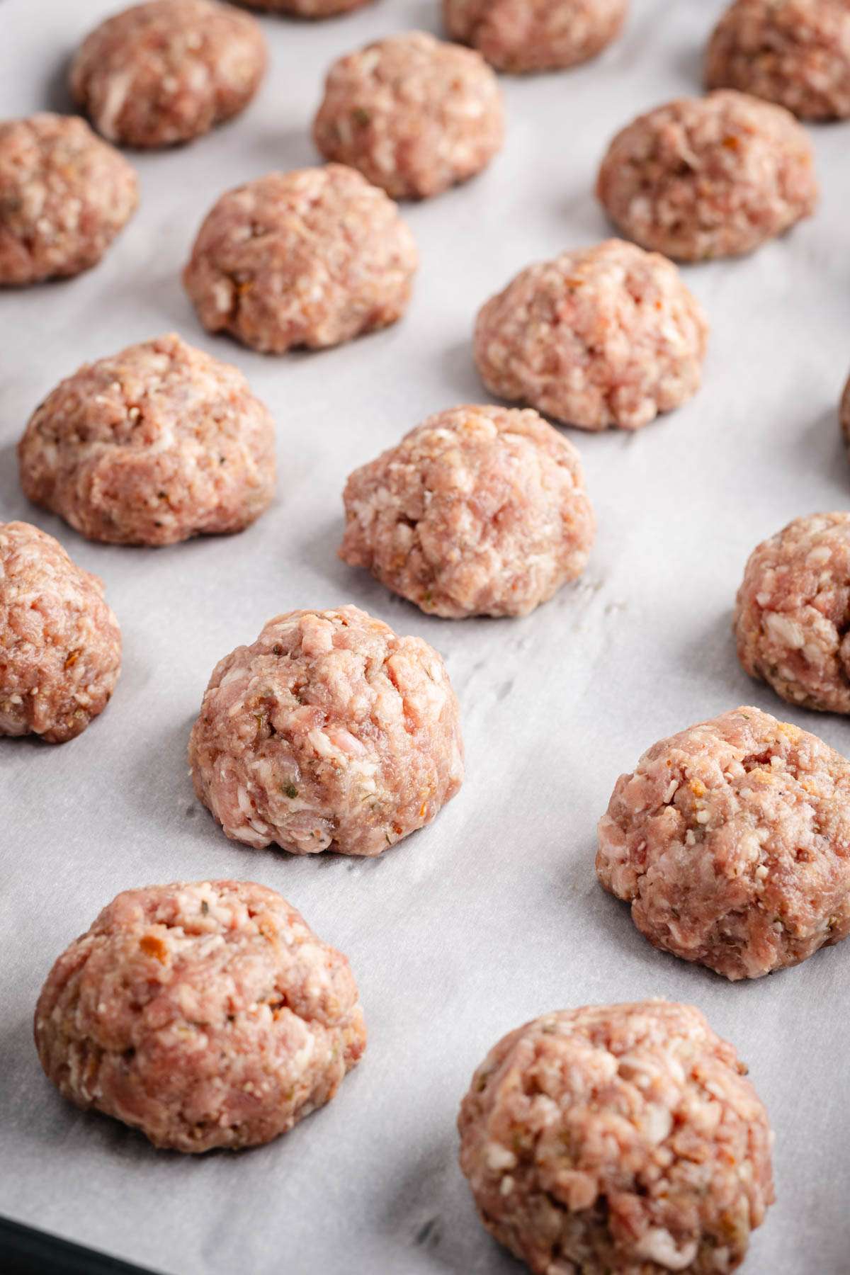 close up of raw meatballs