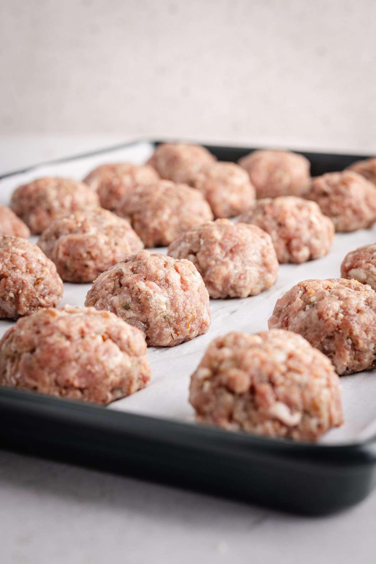 close up of raw meatballs