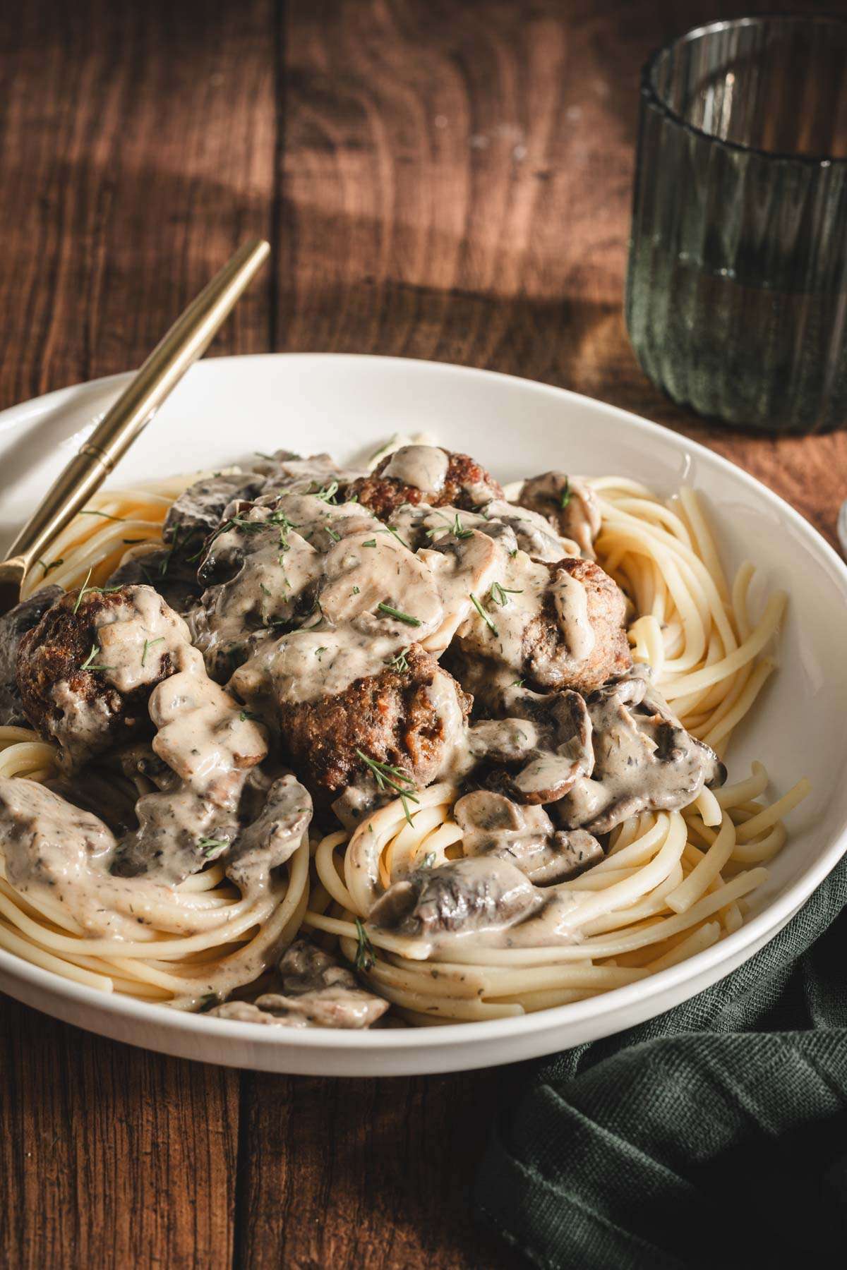 meatballs on a plate with noodles and sauce