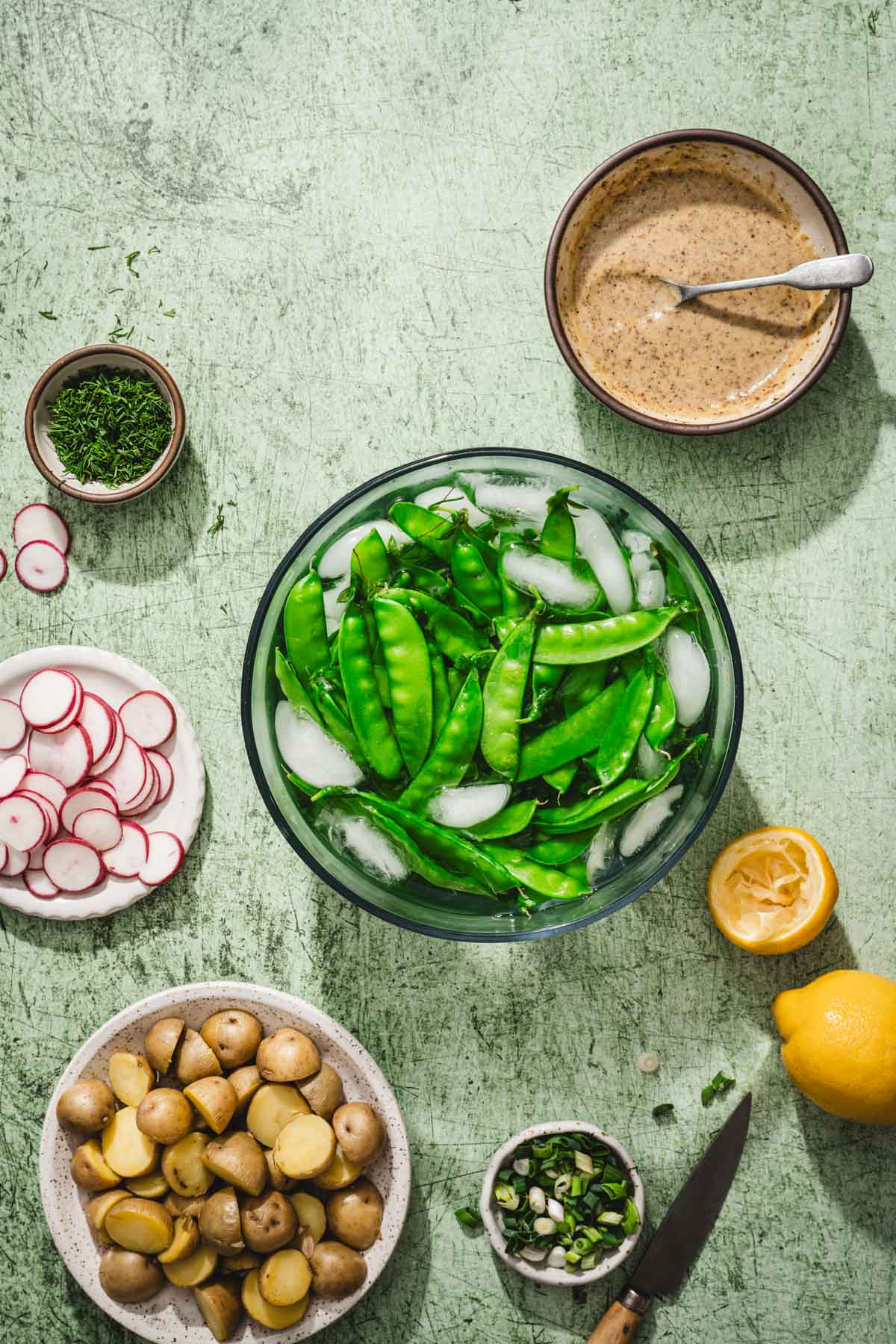 bowl with snow peas in an ice bath