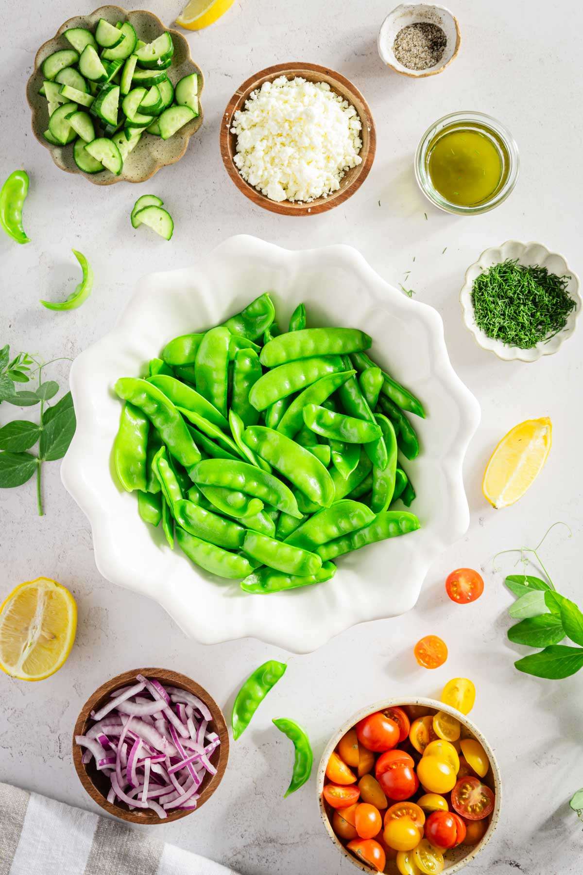 large bowl with blanched snow peas, other ingredients to make the salad around