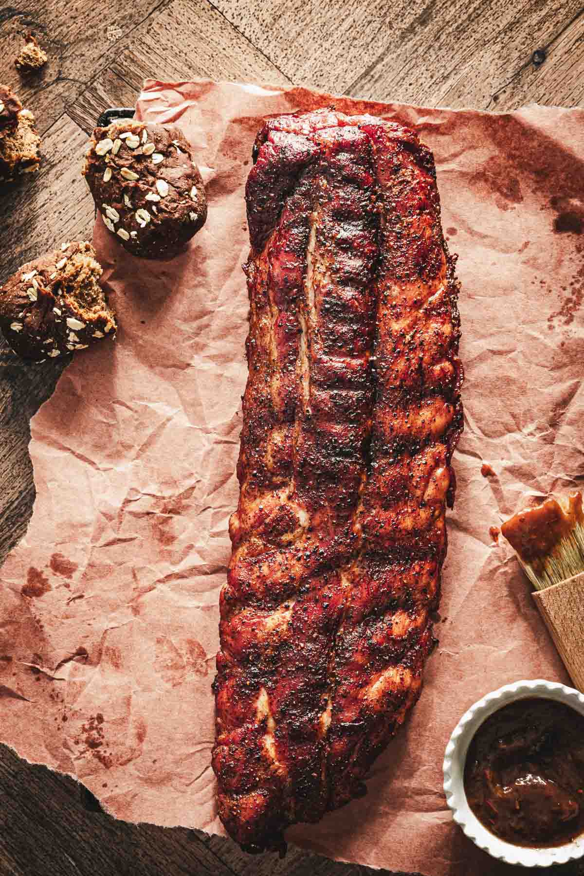 smoked ribs on a peach paper, brush, dish with bbq sauce