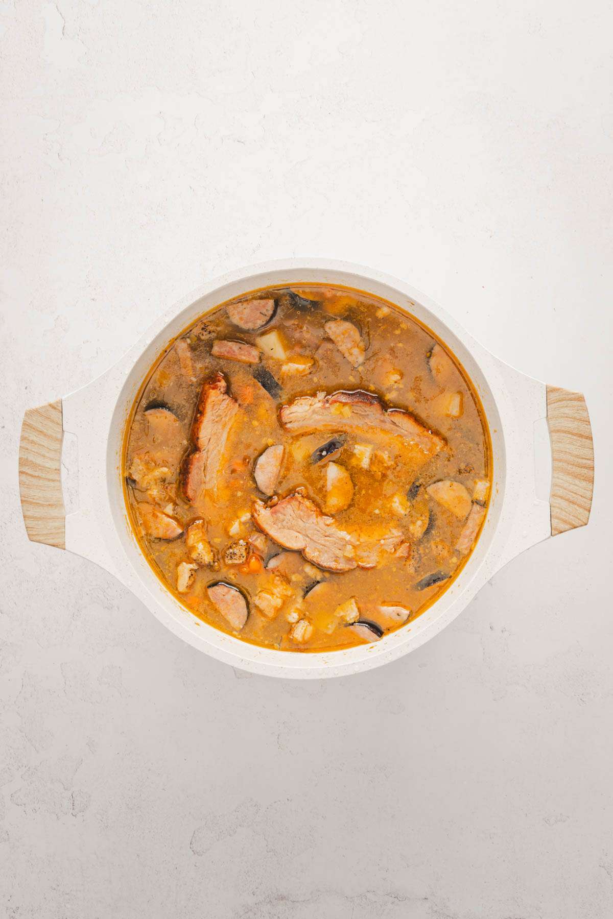 soup pan with cooked soup and meats added