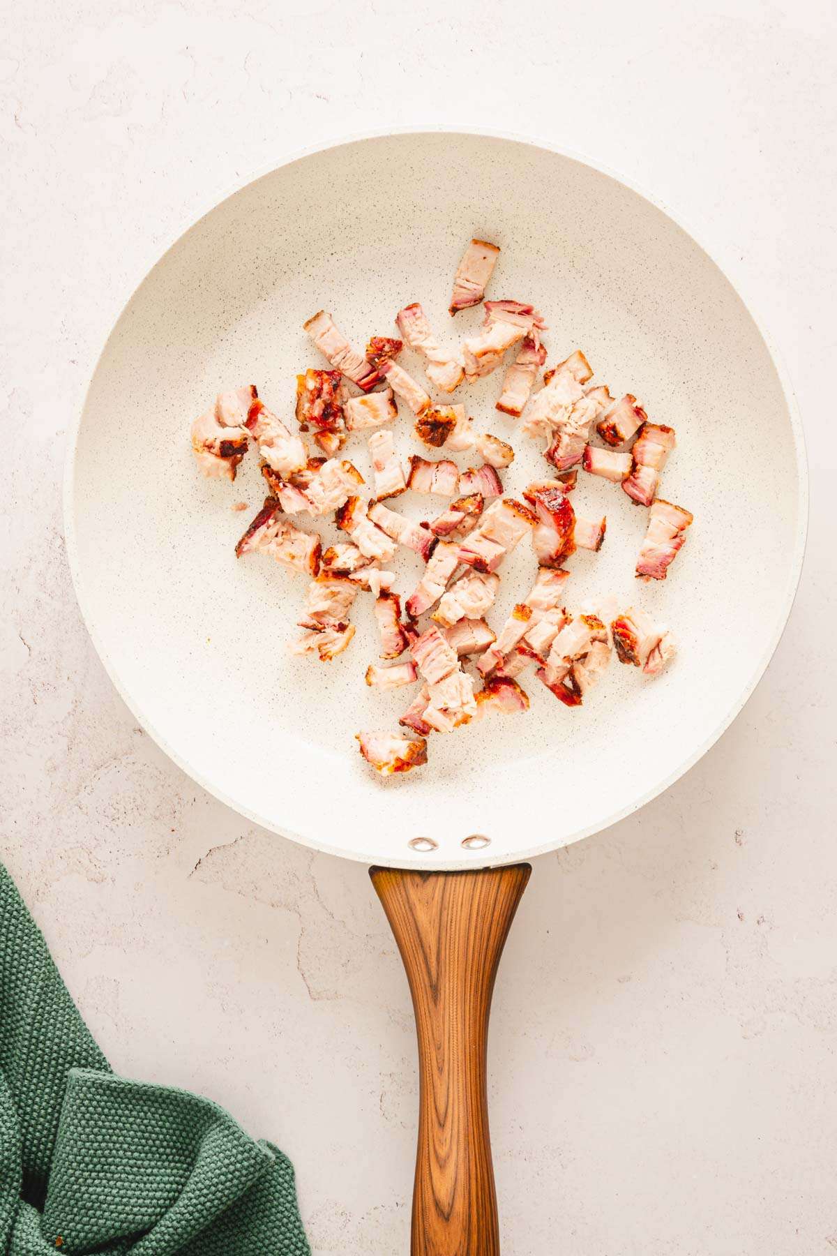 smoked, chopped pork belly in a saute pan