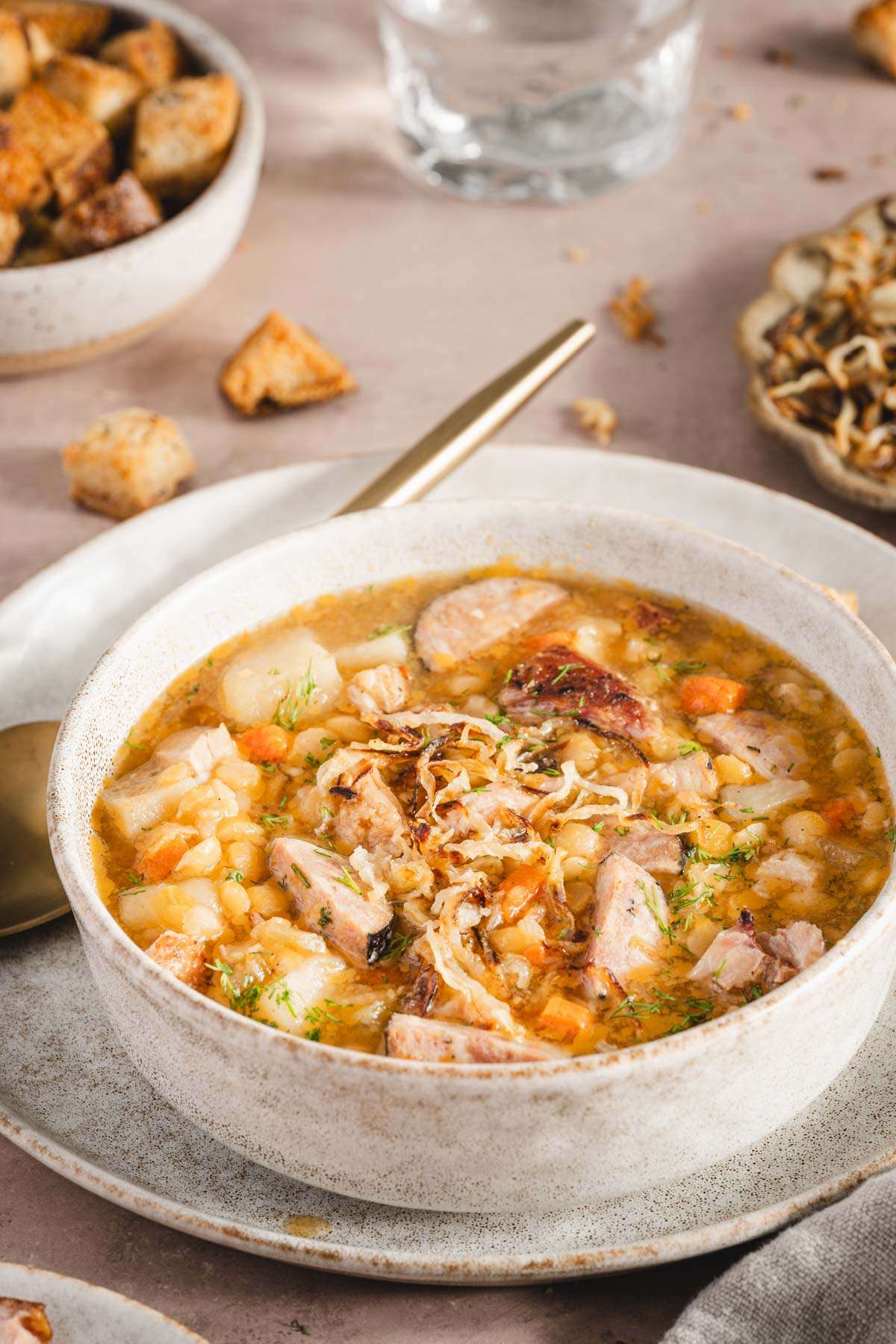 split pea soup in a serving bowl, side view close up