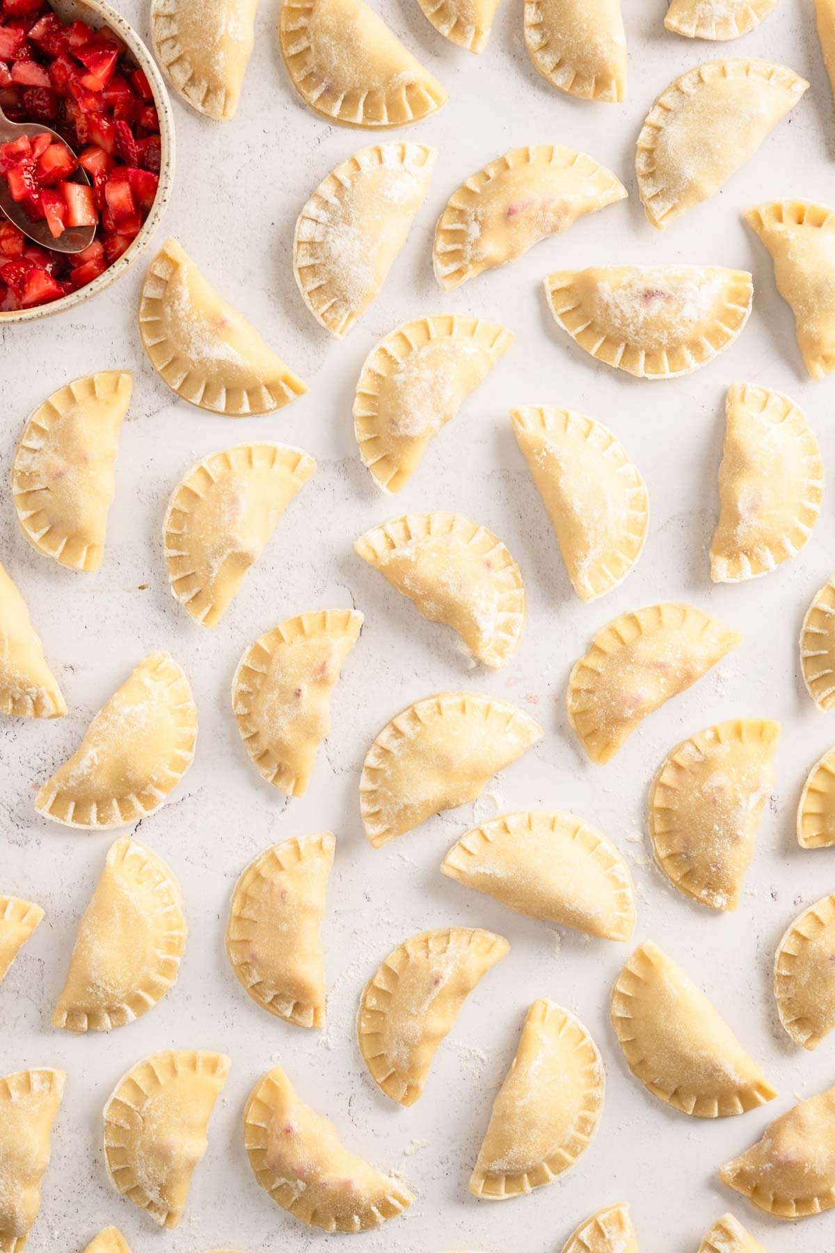 made, raw pierogis , bowl with the strawberry filling