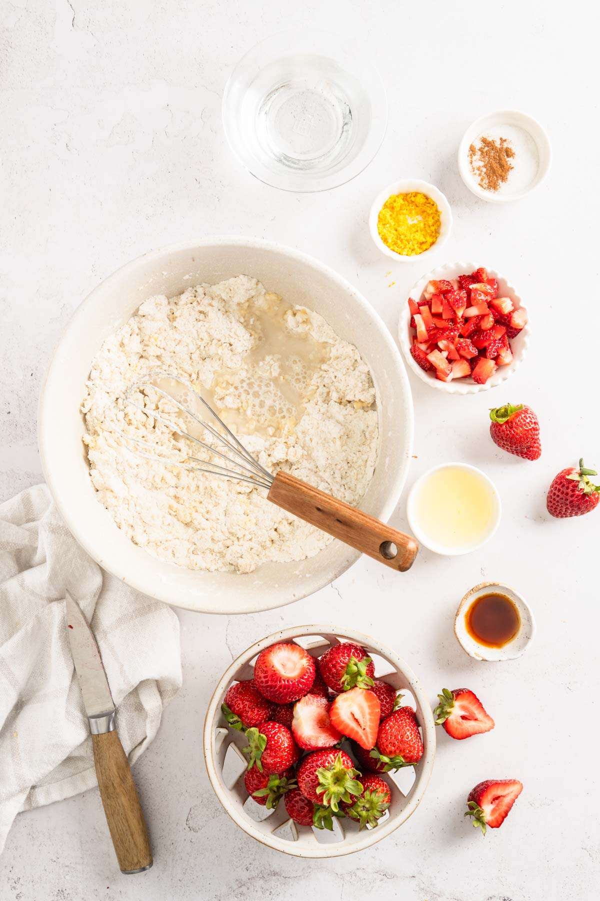 large mixing bowl with flour mixed in with other wet ingredients