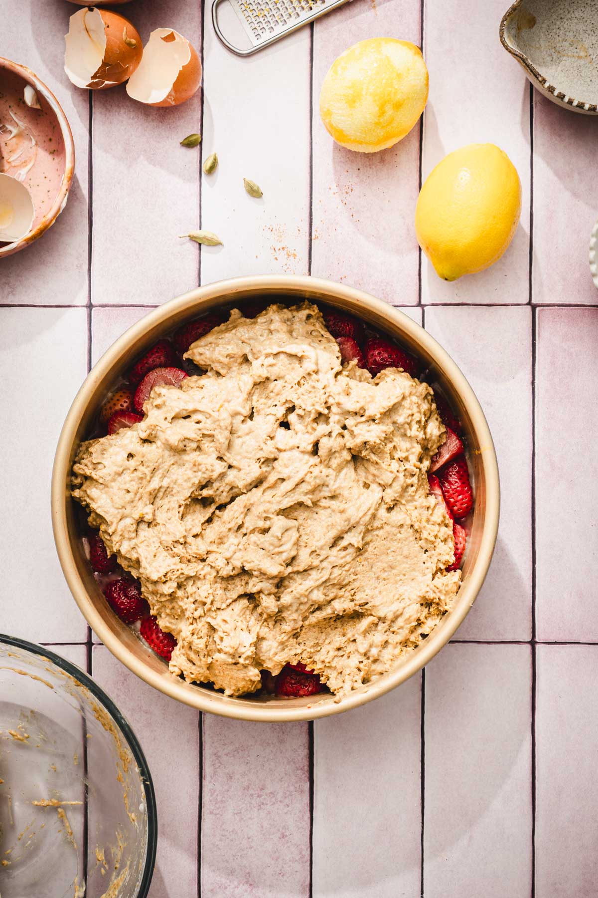 round pan with strawberries and batter on top