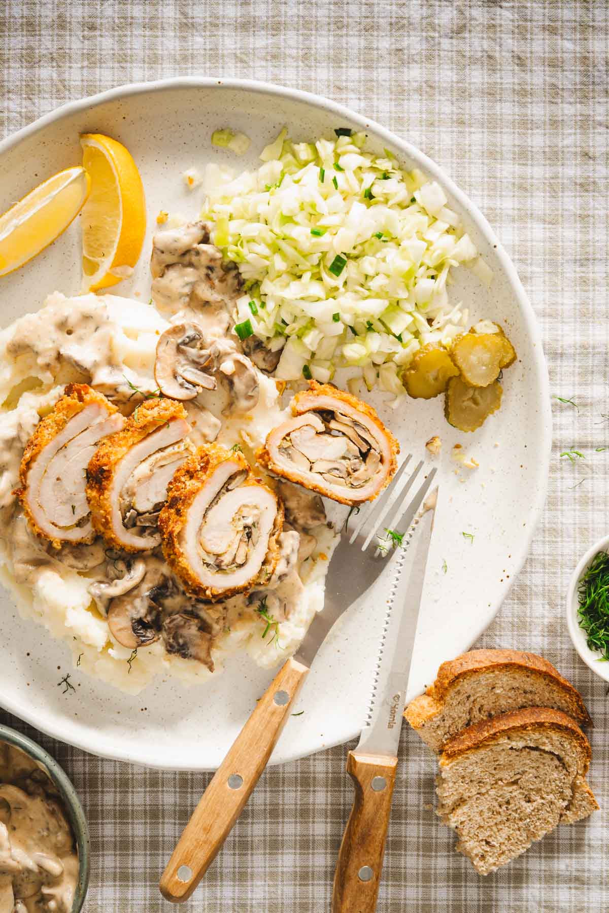 stuffed pork chop cut into slices, cabbage salad lemon wedges