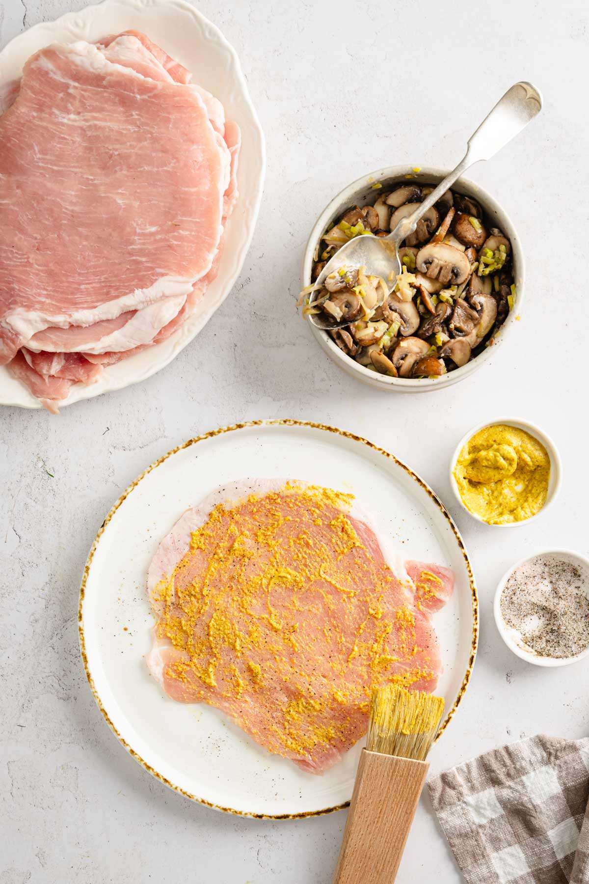 raw pork chop covered with a layer of mustard