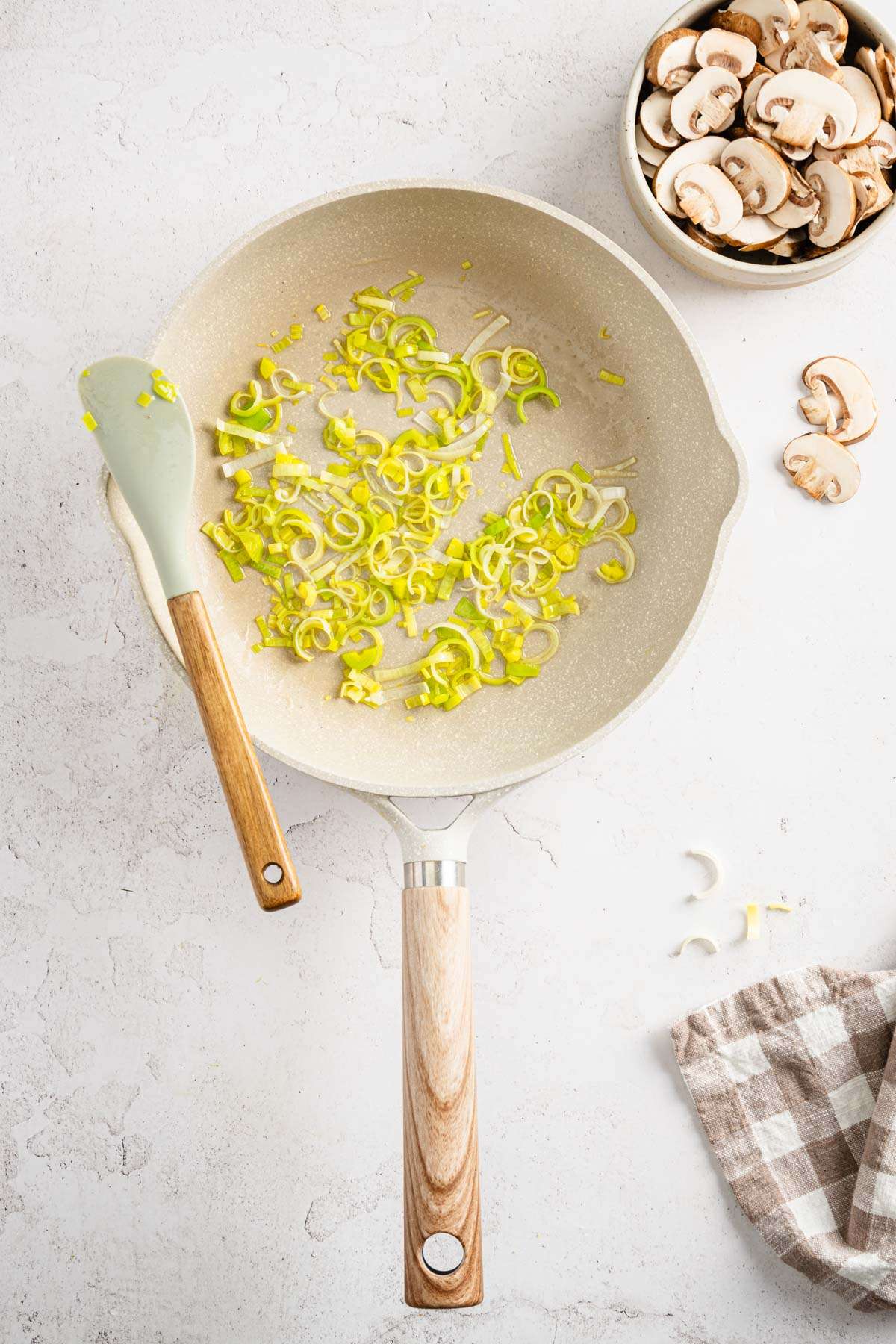 leeks sautéed in the pan, bowl with mushrooms