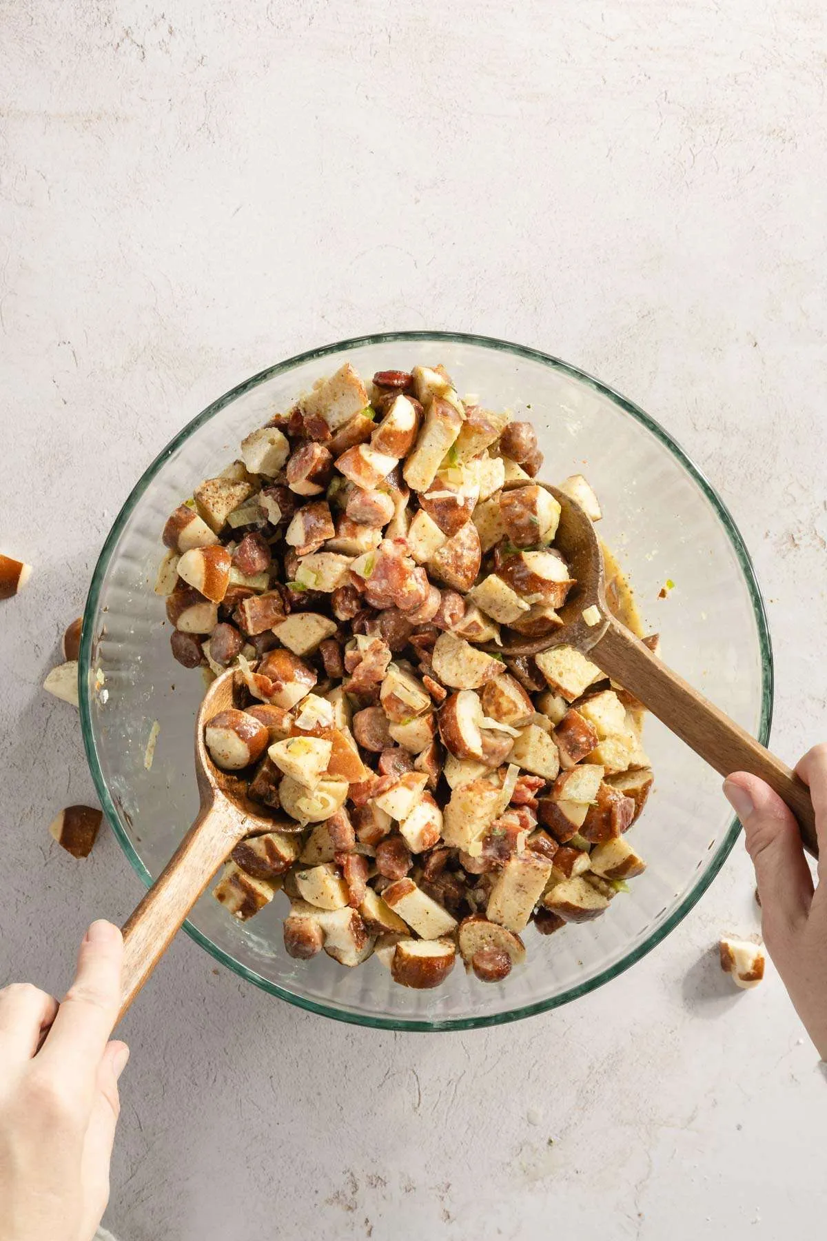 hands in frame mixing the stuffing with two large spoons