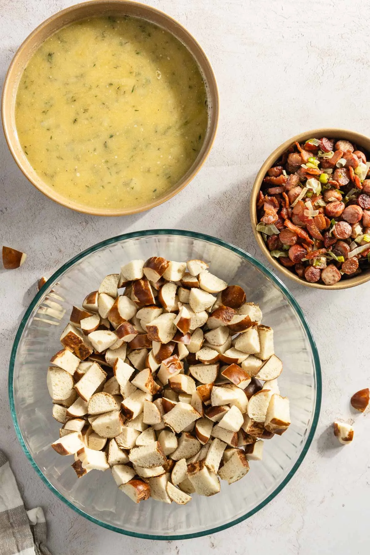 bowl with the sauce, one with toasted pretzel and one bowl with the three meats