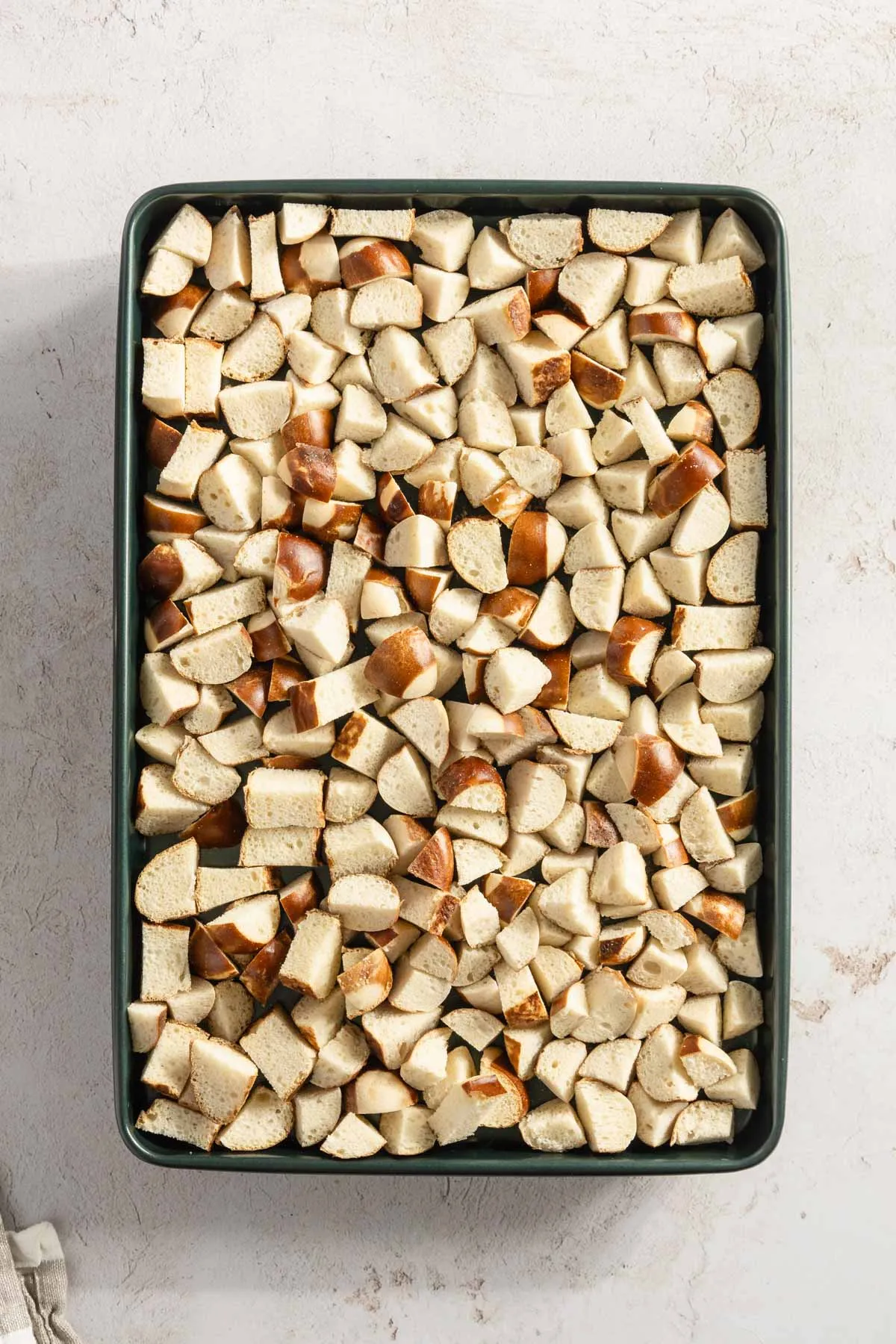 roasted pretzels cut into small bites, on a baking sheet