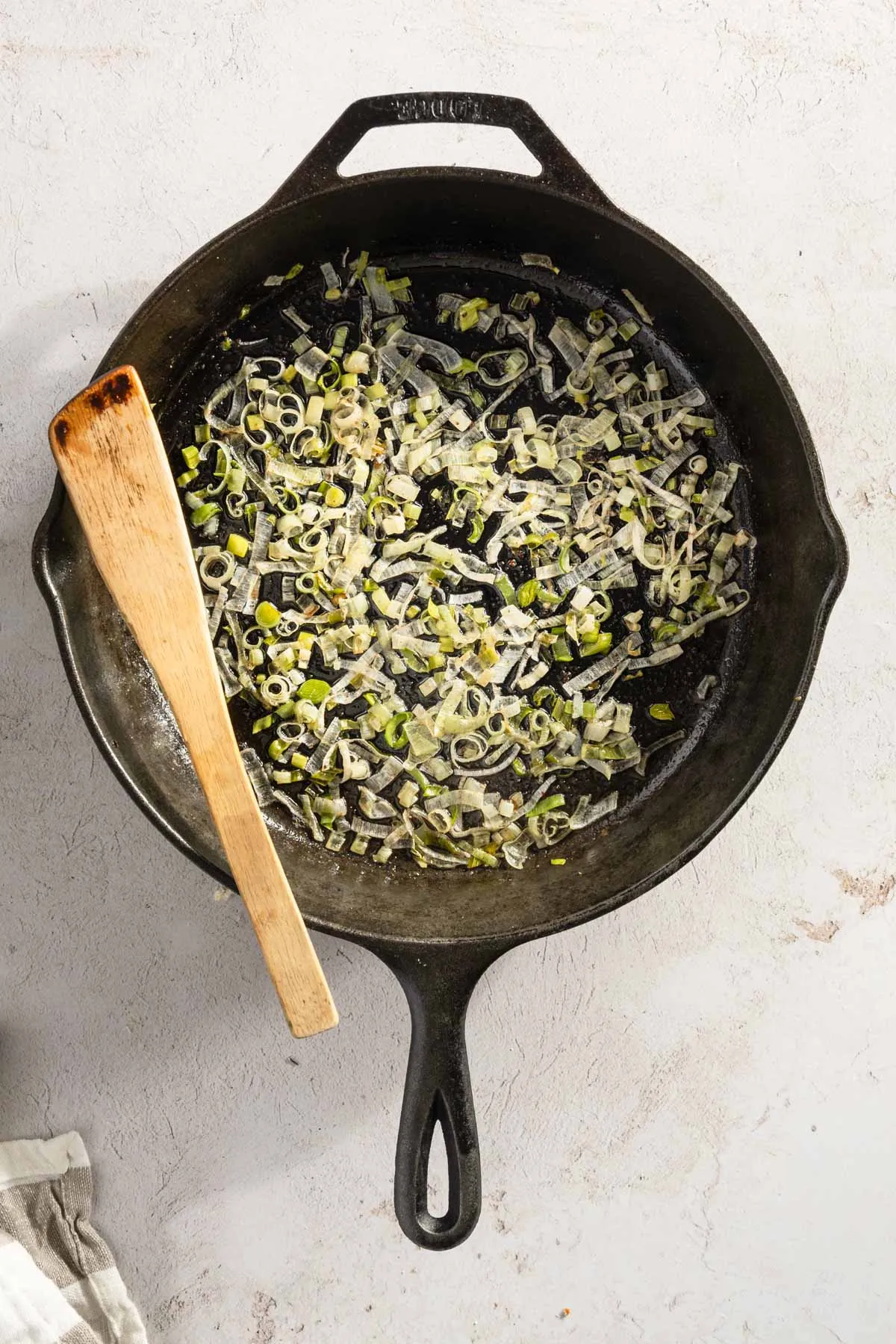 cooked sliced leeks in a cast iron pan
