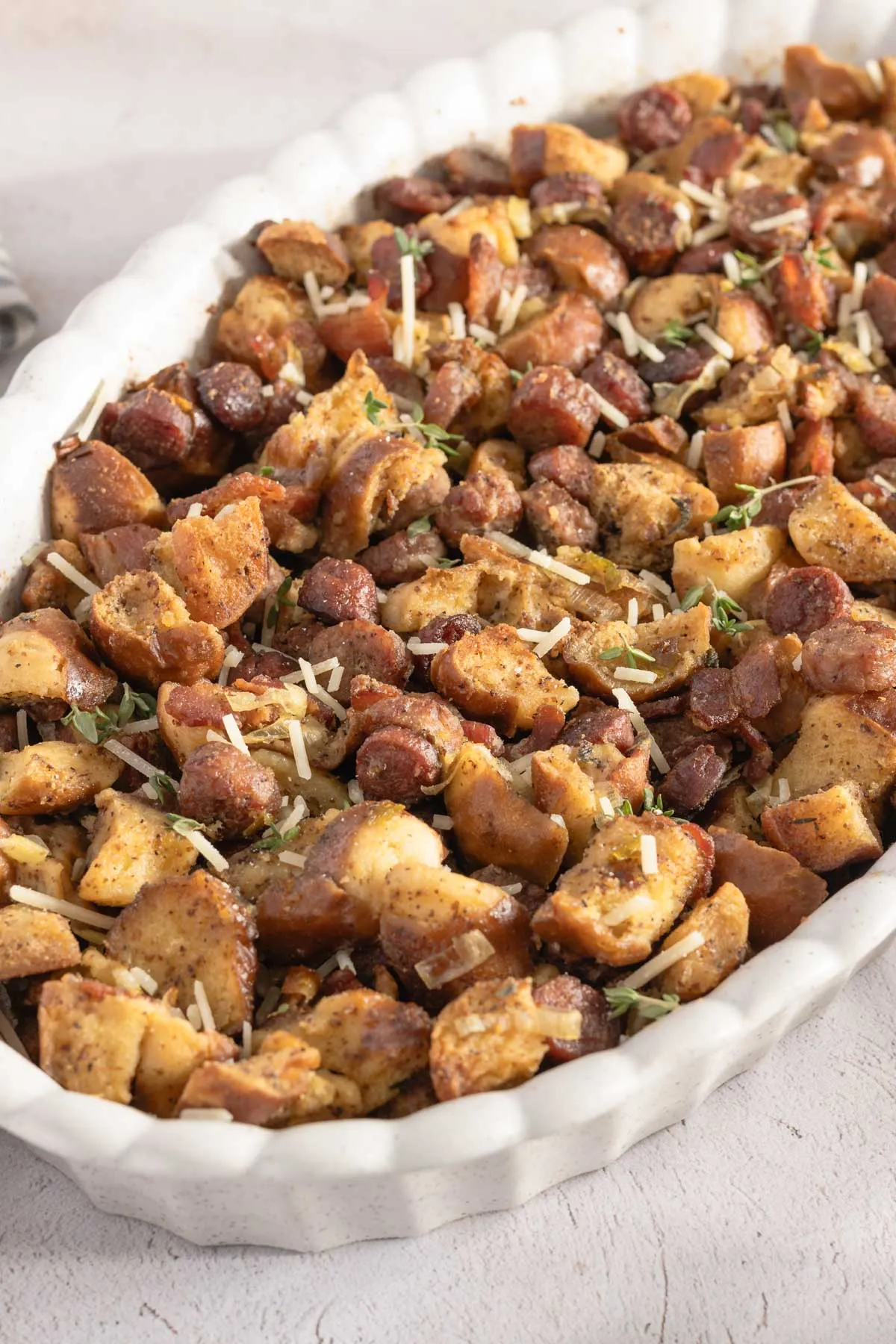 cooked three meat pretzel stuffing stuffing in an oval baking dish, close up