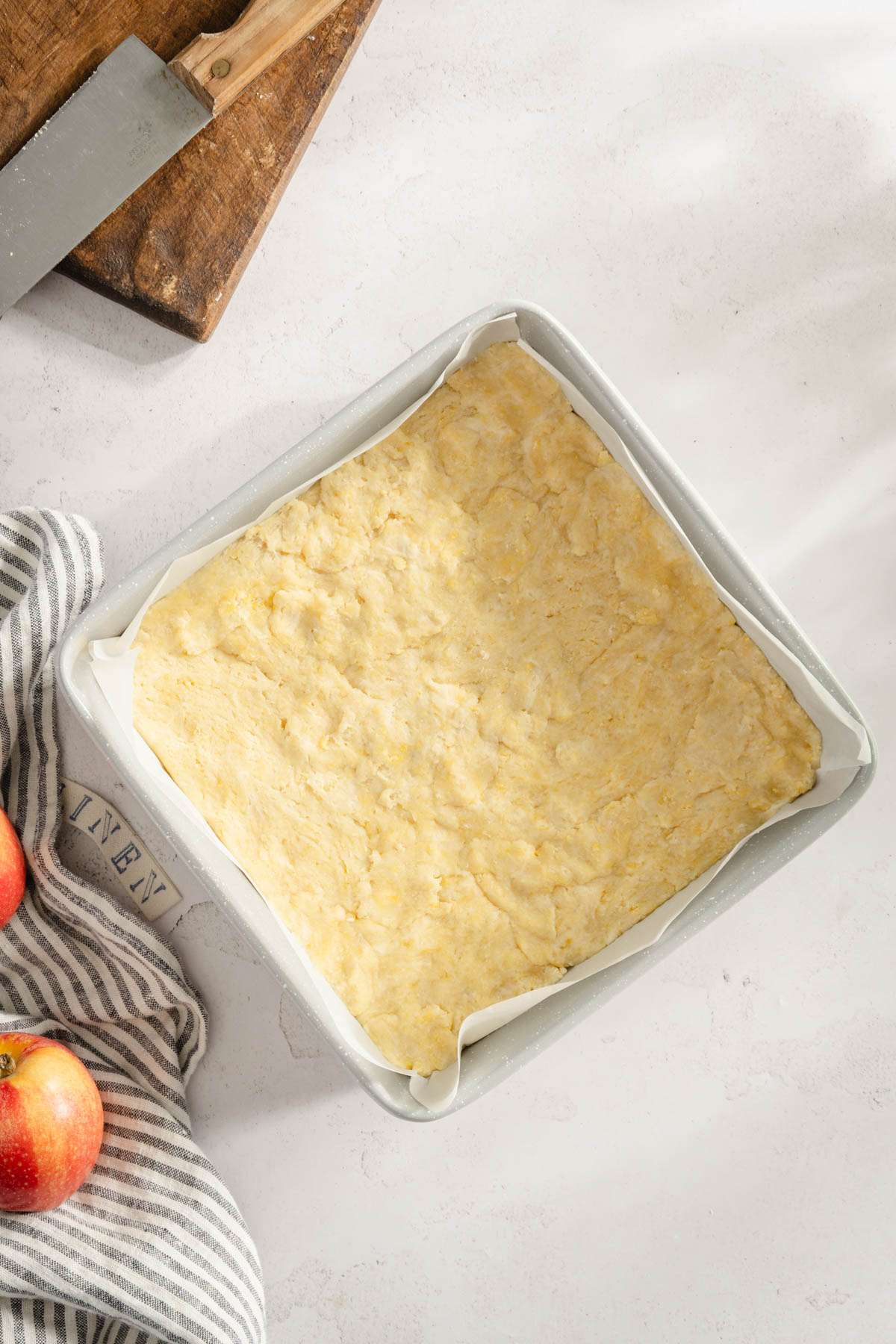 baking dish with dough pressed into it