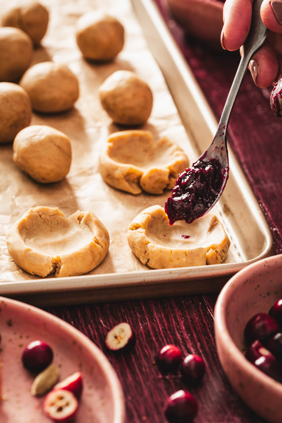 spoon in frame with the cranberry sauce over the cookie dough