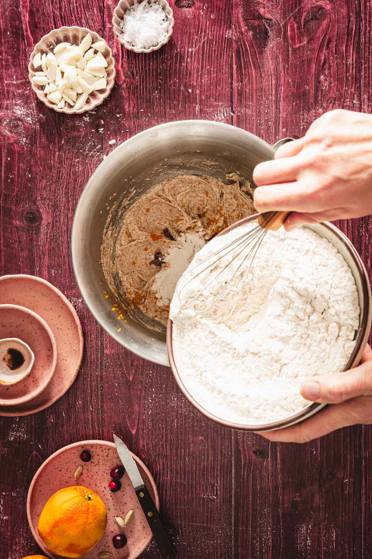 adding flour mixture to the bowl with butter