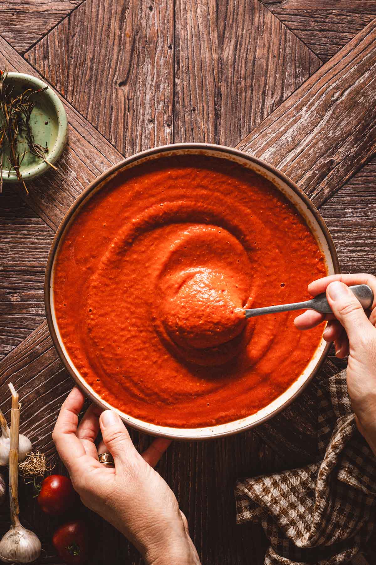 hands in frame stirringtomatosauce