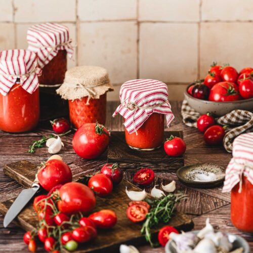 jars with tomato sauce, fresh tomatoes