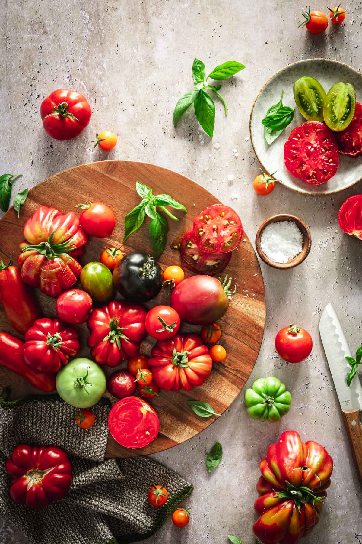 various tomatoes on a round cutting board