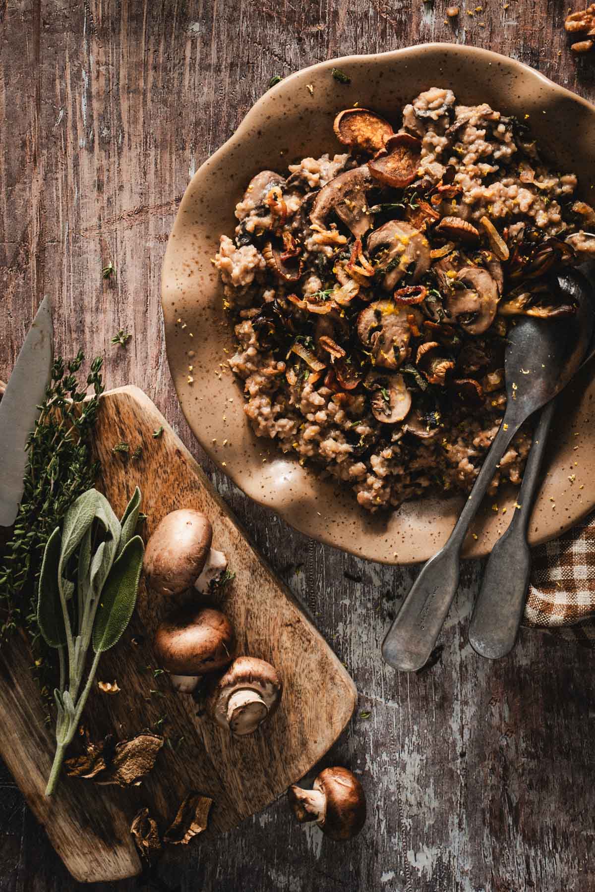plate with risotto, cutting board with herbs
