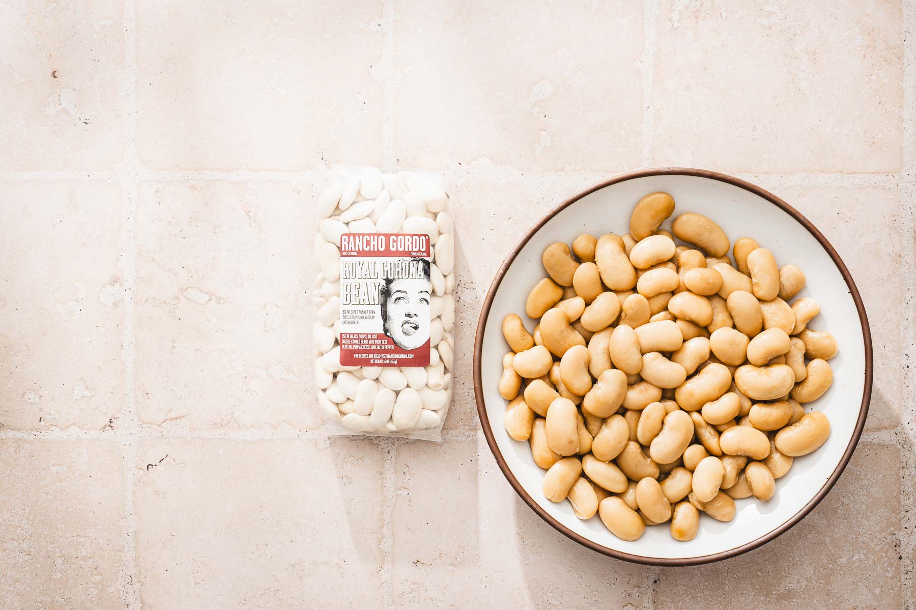 large bowl with cooked bans, bag with dry beans