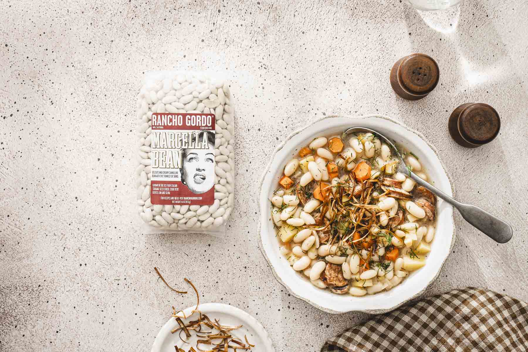 landscape view of a bowl with a soup, bag with raw beans