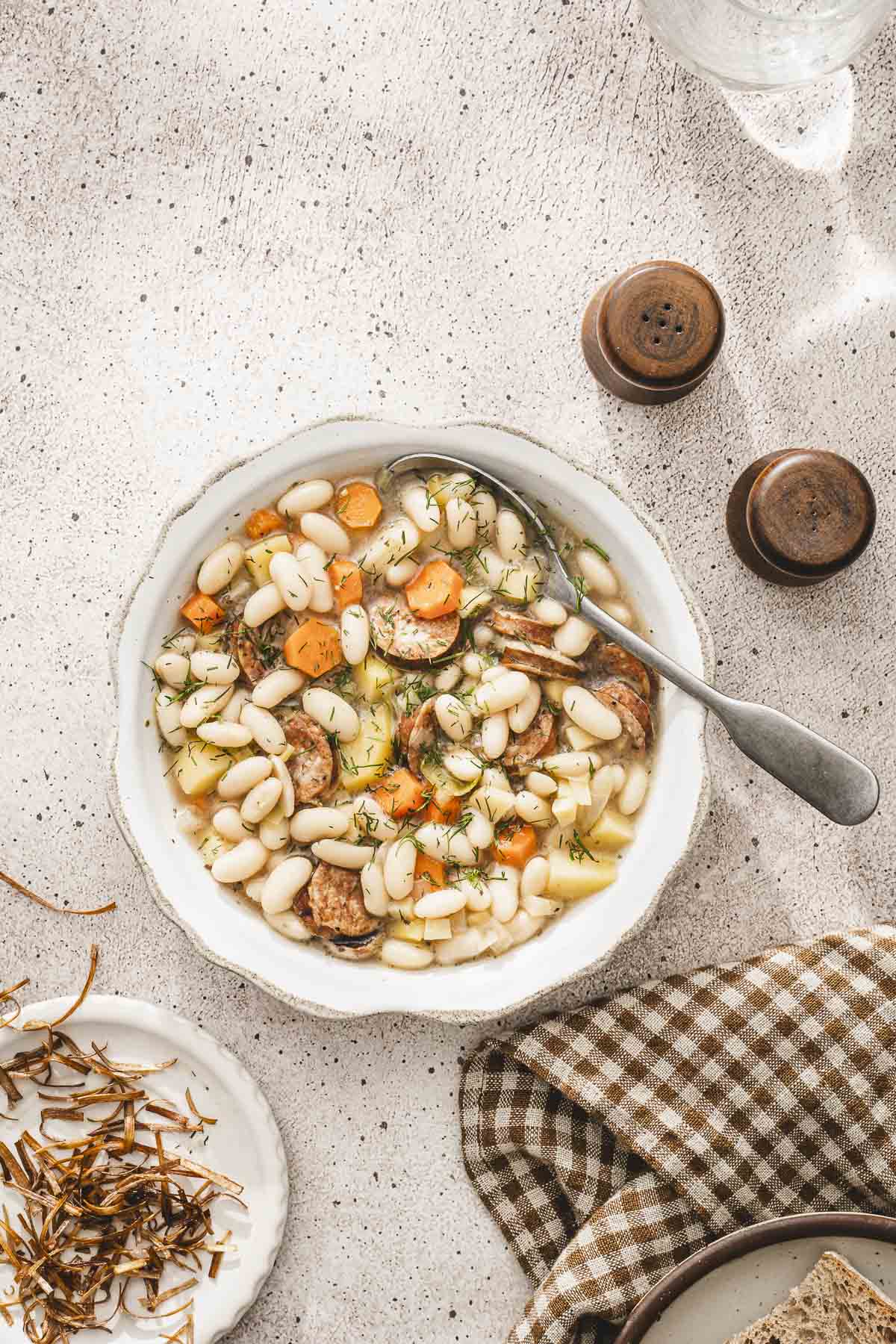 top view of a bowl with the soup, salt, pepper, napkin