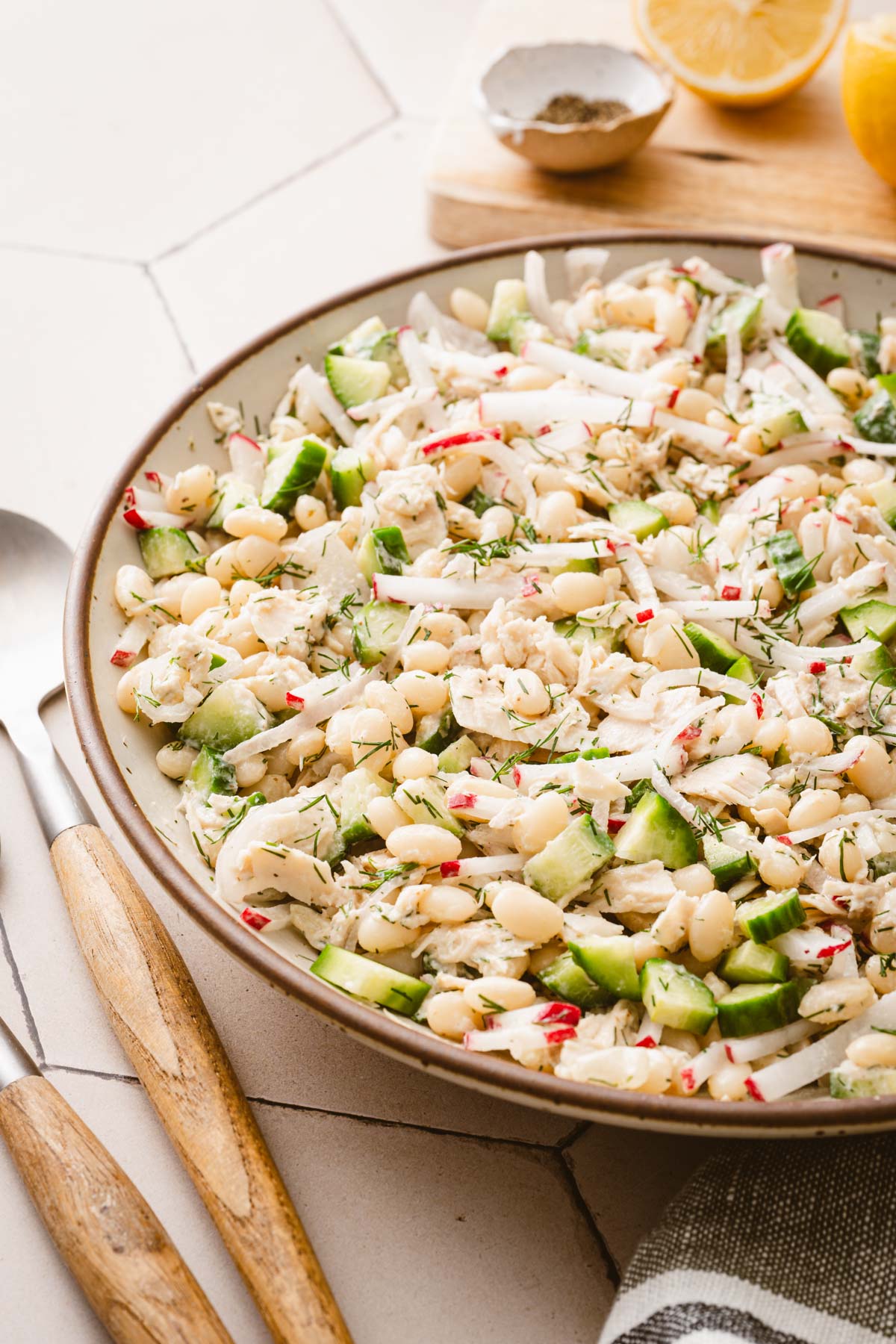 sid view of the bowl with salad, serving utensils
