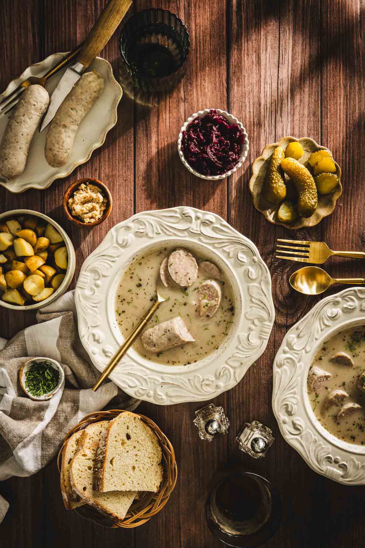 zurek in soup bowls served with biala kielbasa