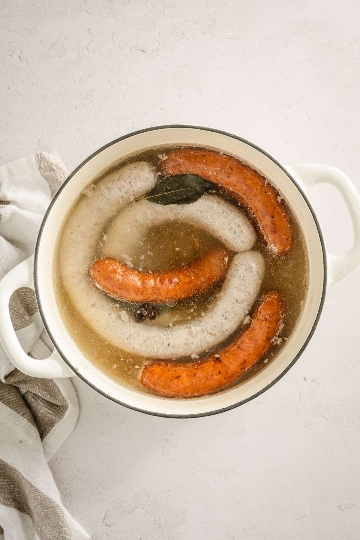 top view of stock pot with cooked sausages