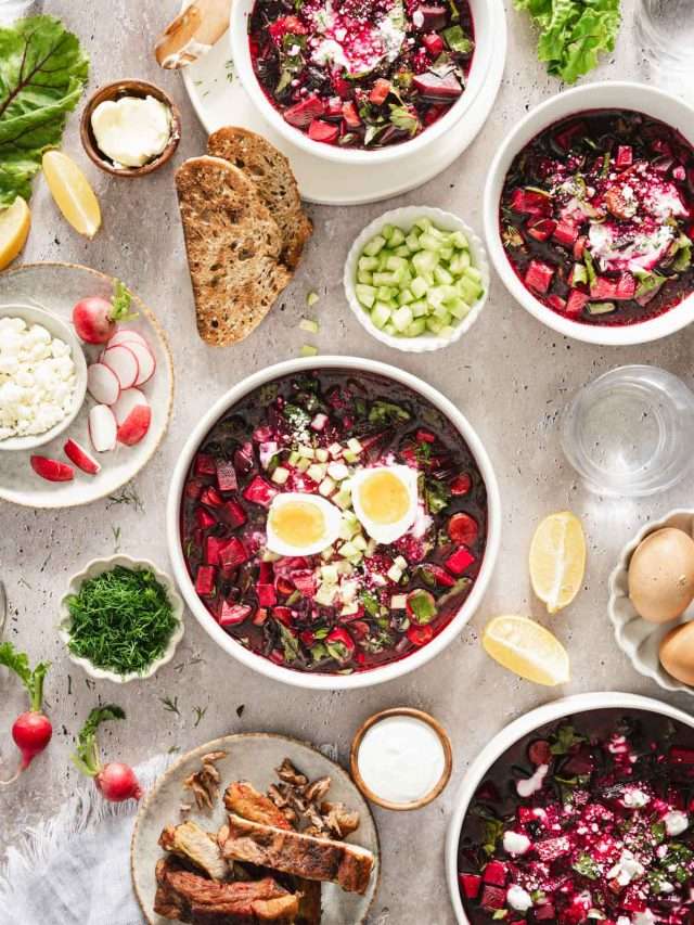 on a light background, botwinka soup in a serving bowl, garnished with an egg, beet leaves, fresh dill, cucumbers, full size scene